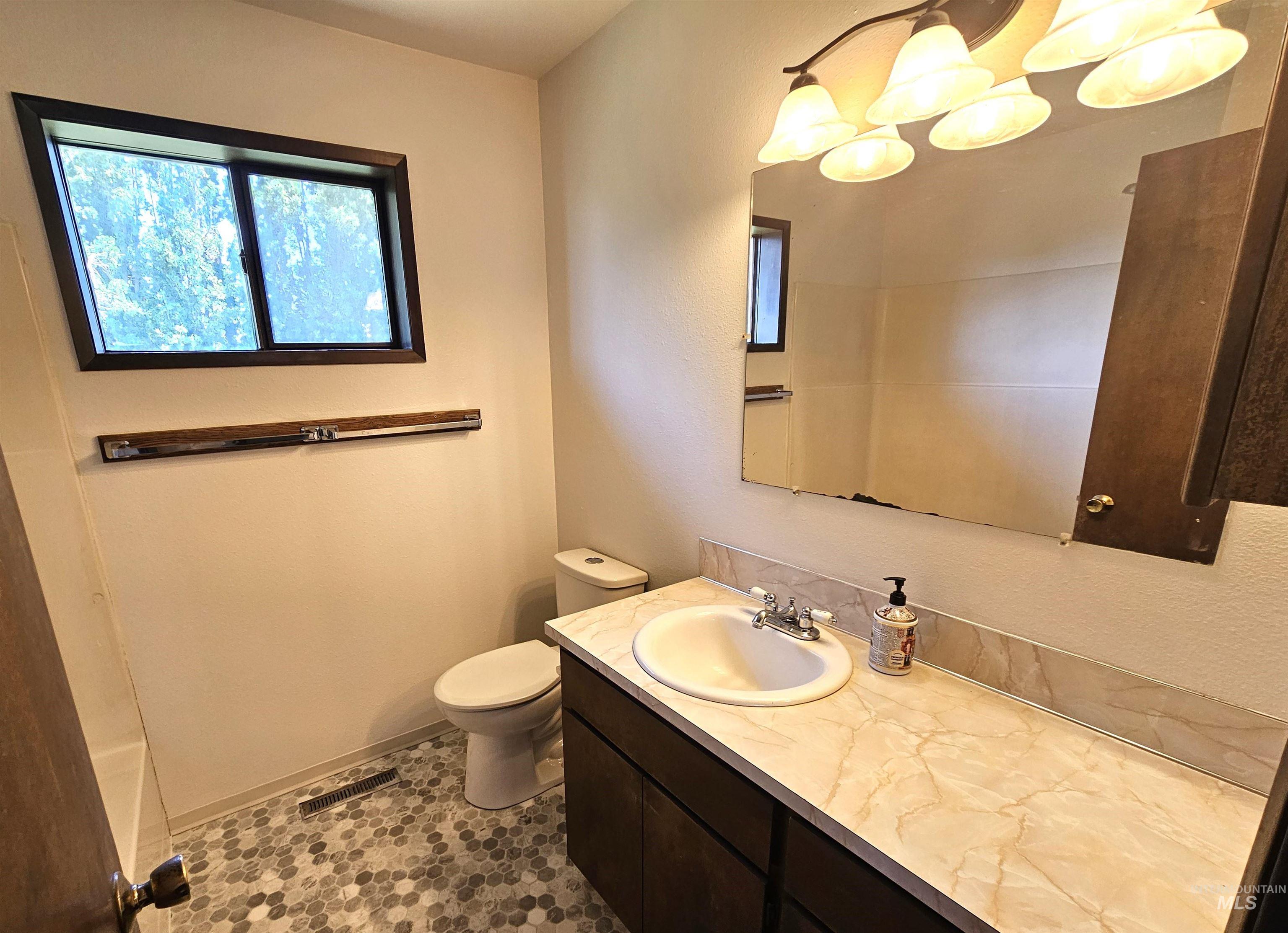 Full bathroom featuring vanity and a chandelier
