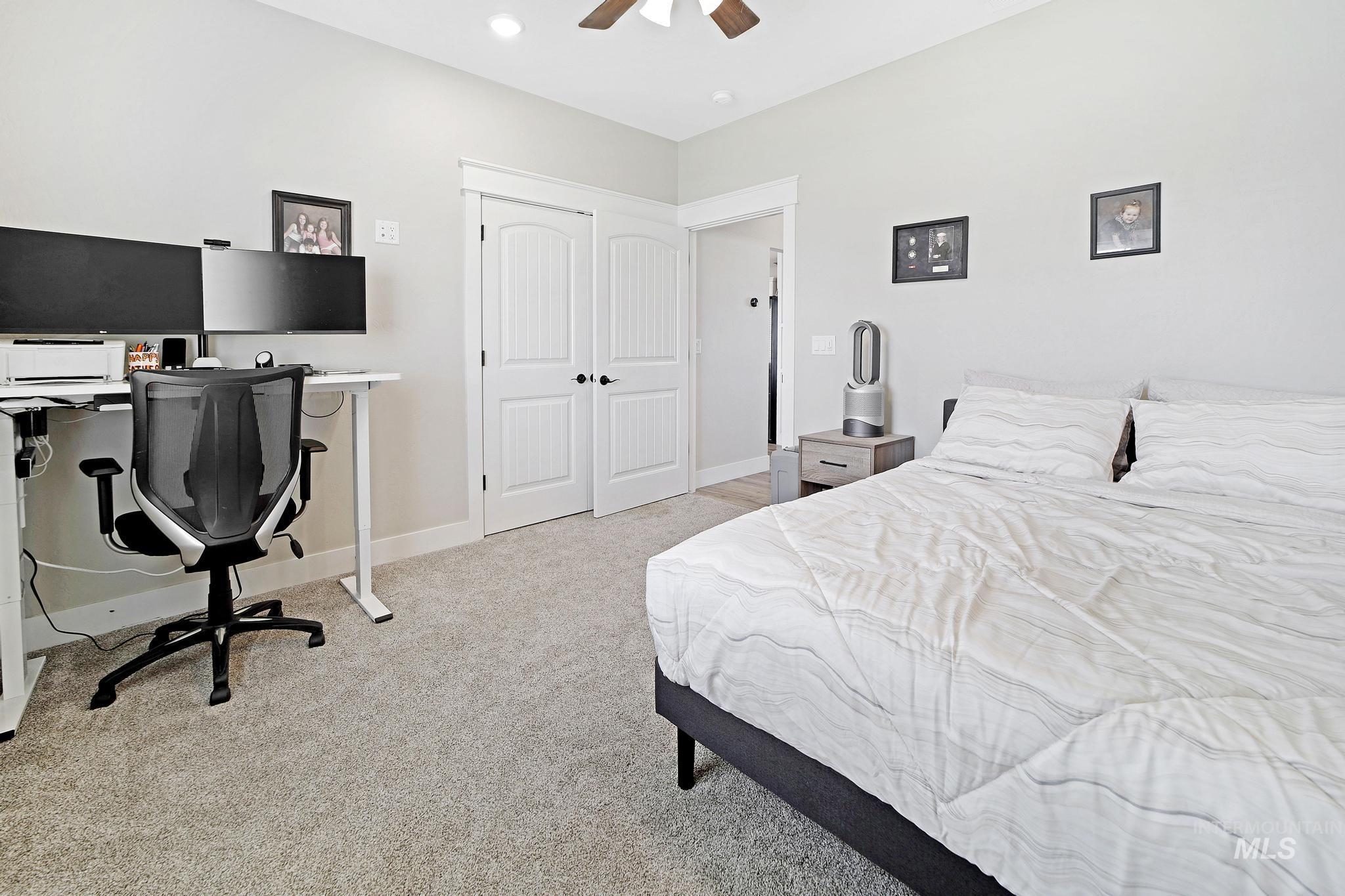 Bedroom featuring an office area, light carpet, ceiling fan, and recessed lighting