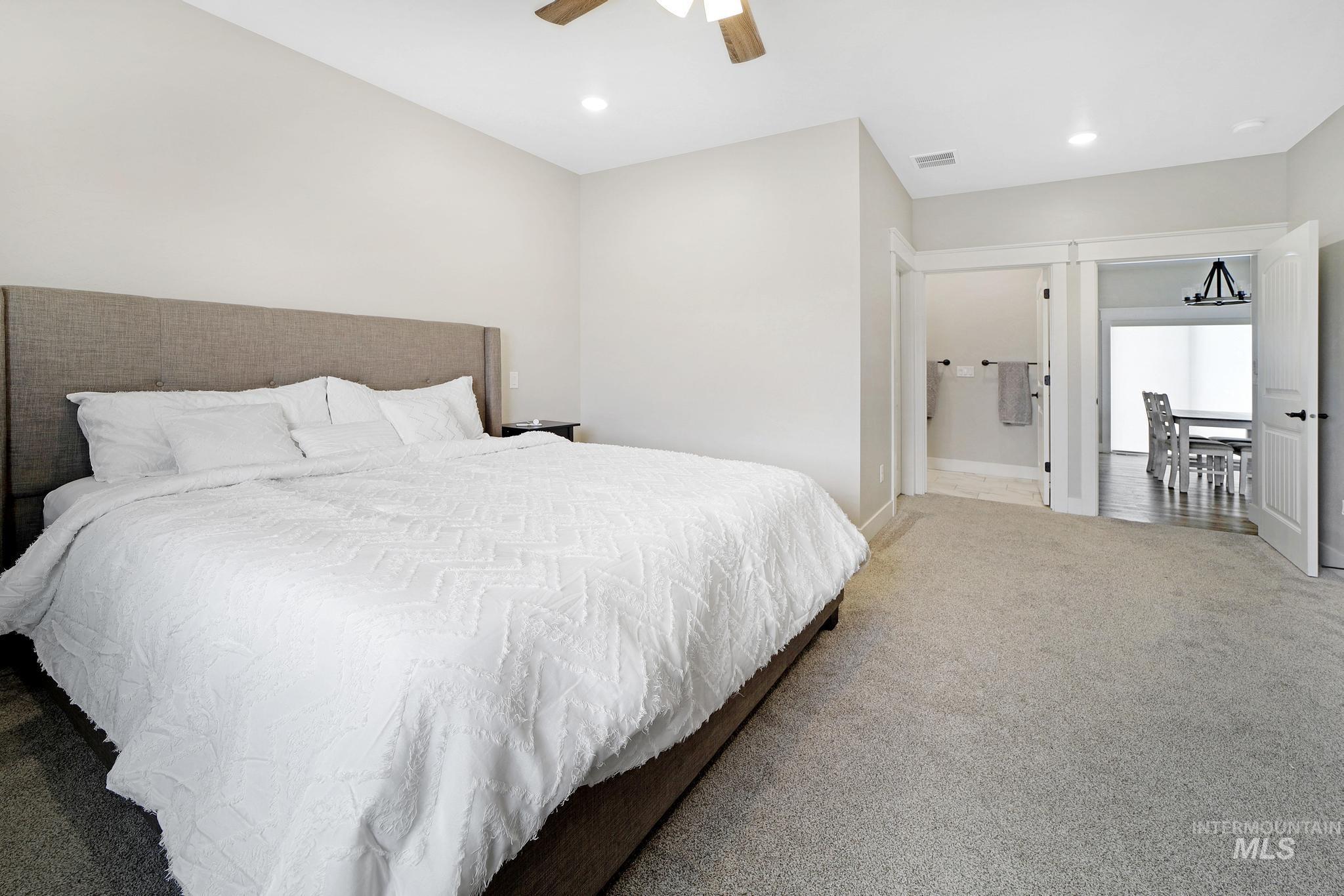 Bedroom featuring carpet, connected bathroom, recessed lighting, and ceiling fan