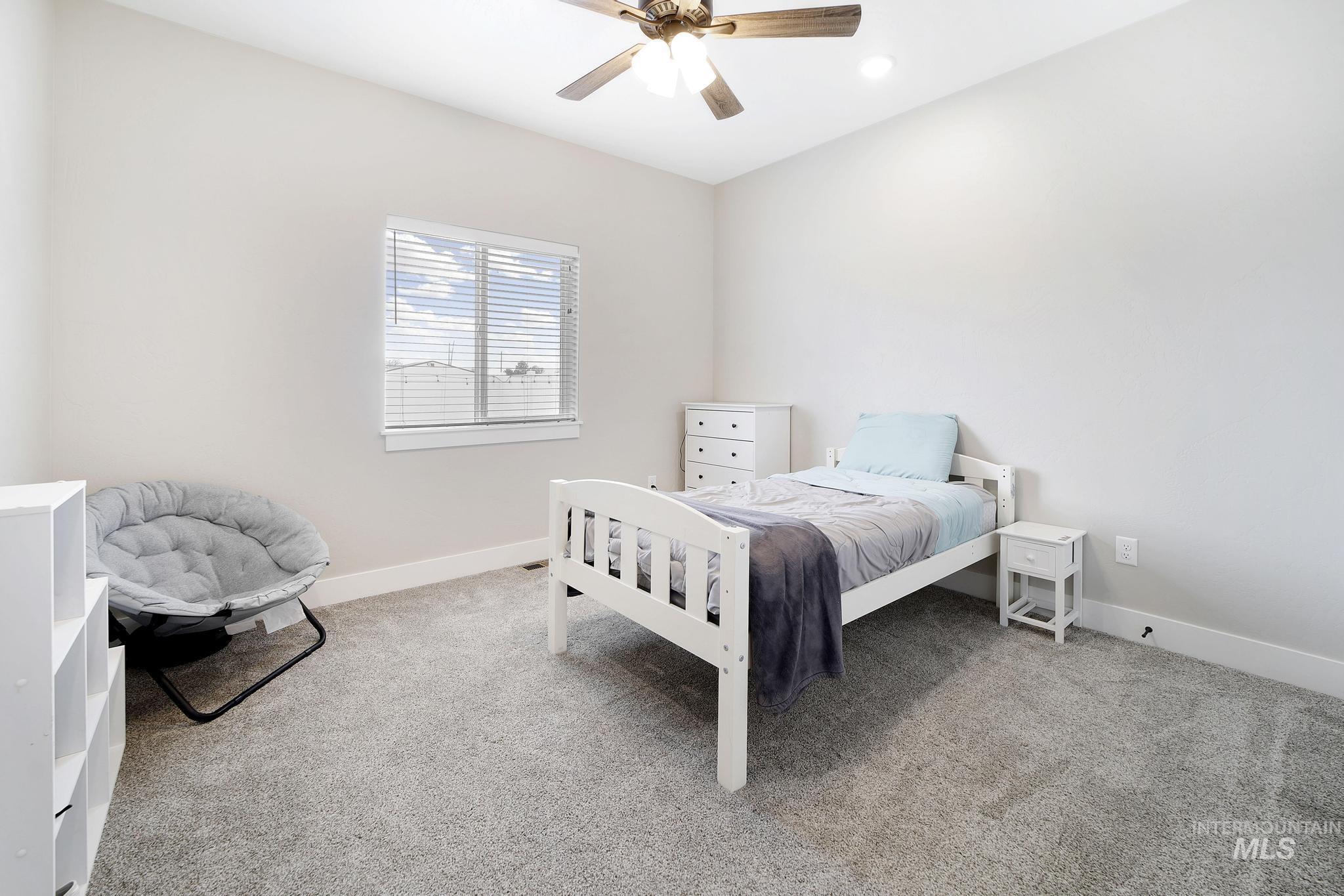 Bedroom with carpet floors, ceiling fan, and recessed lighting