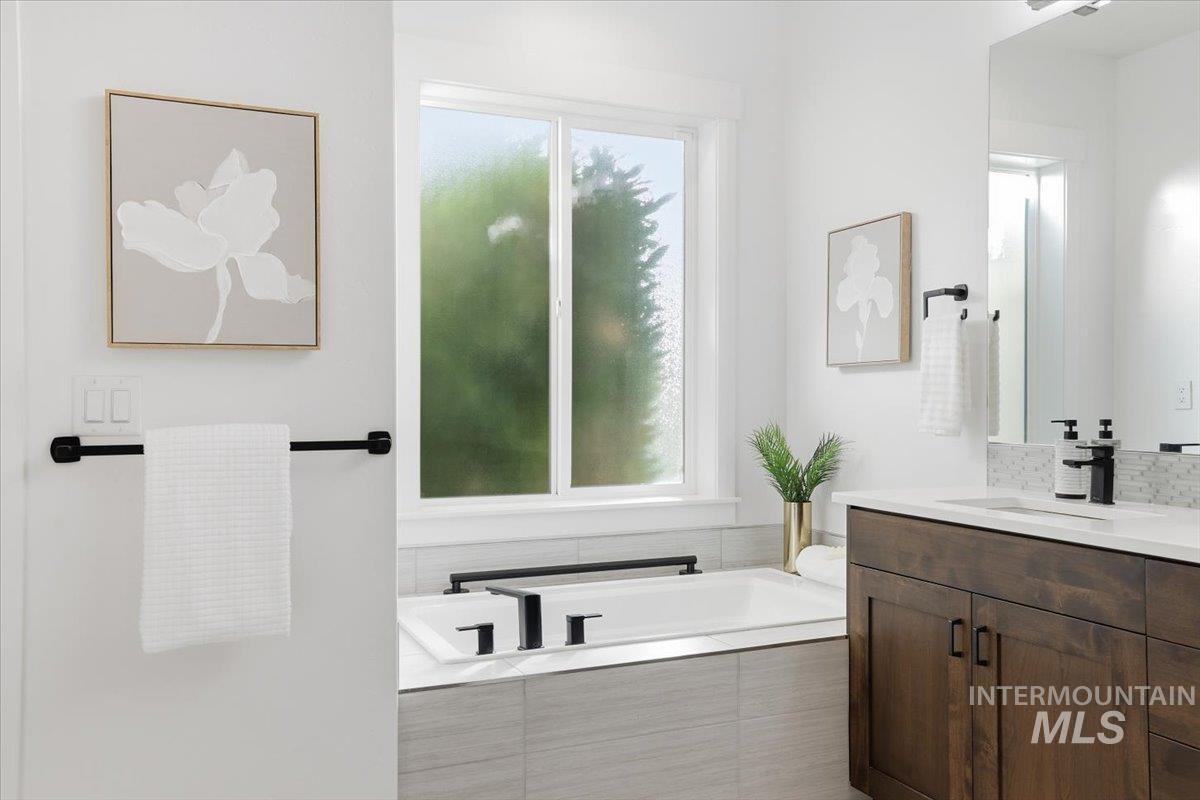 Bathroom featuring a bath and vanity