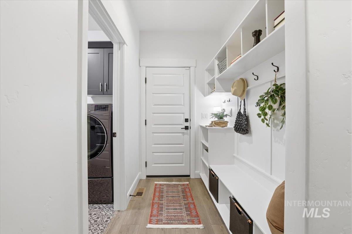 Mudroom featuring light wood-style floors and washer / clothes dryer