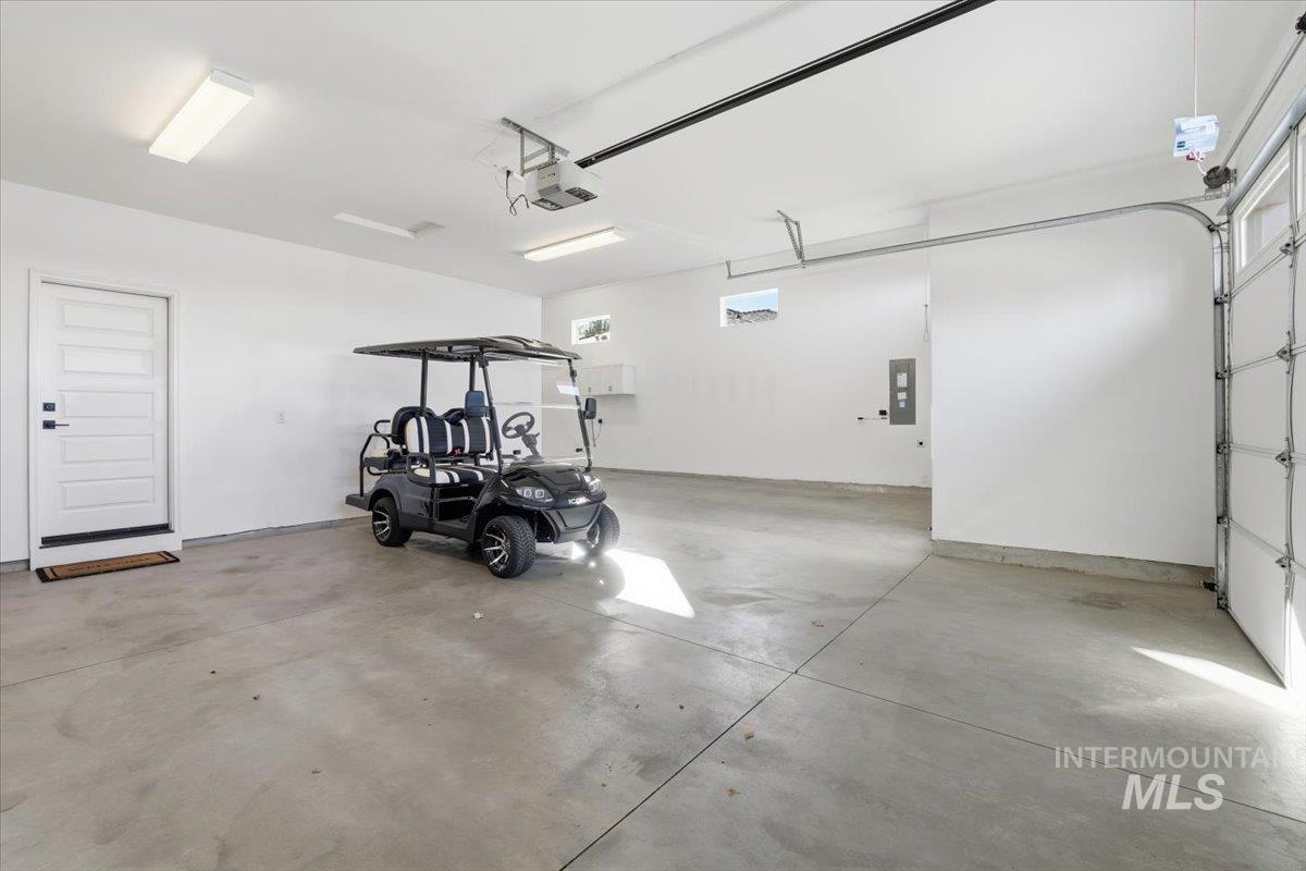 Garage with electric panel and a garage door opener