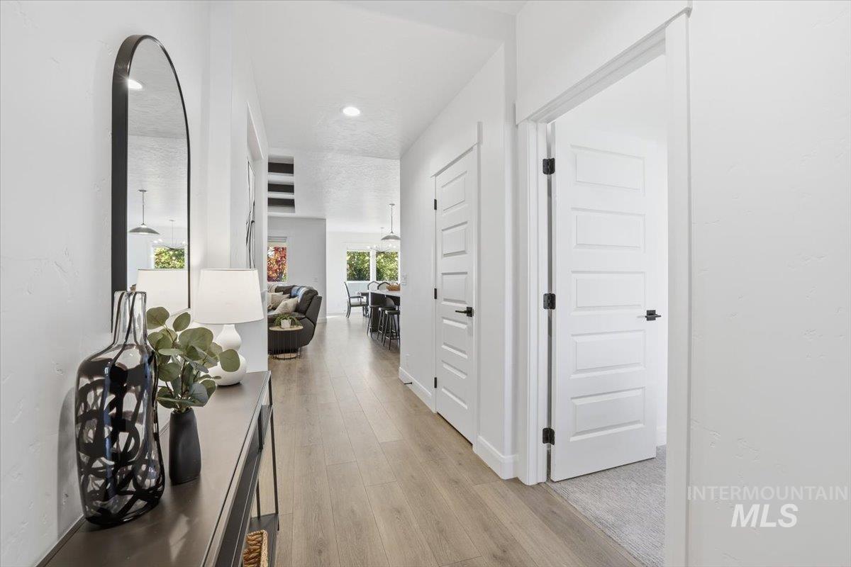 Corridor with light wood finished floors and baseboards