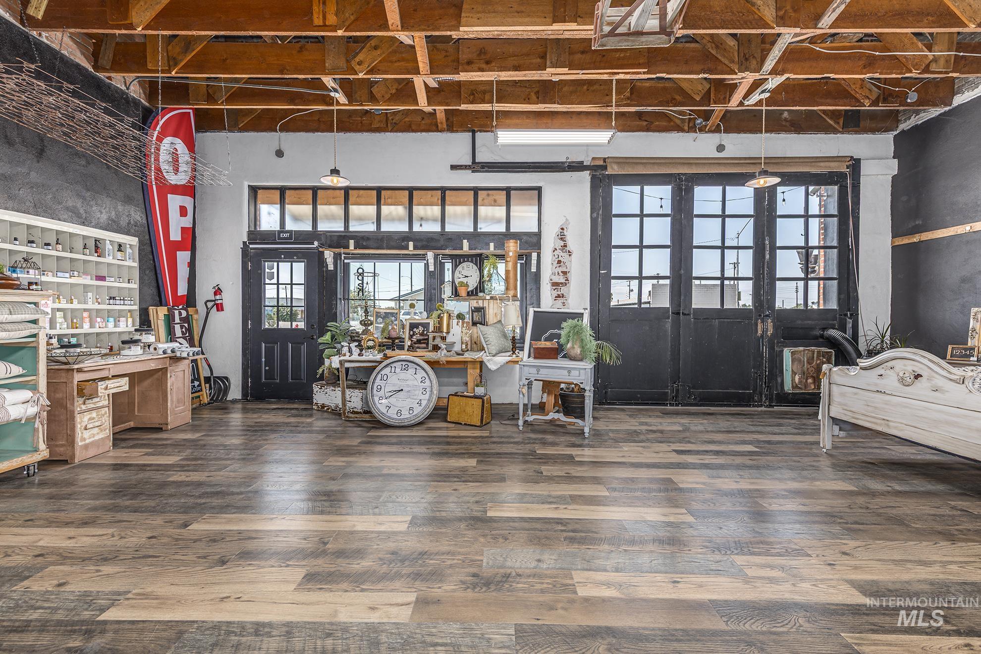 Miscellaneous room with wood finished floors, a high ceiling, and a workshop area