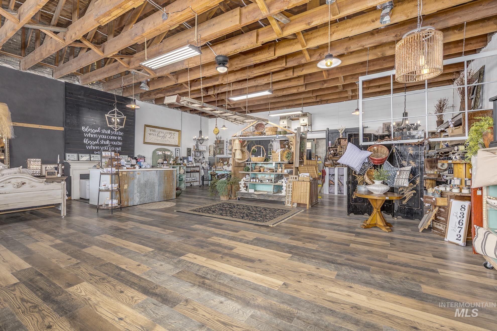 Misc room featuring wood finished floors and a chandelier