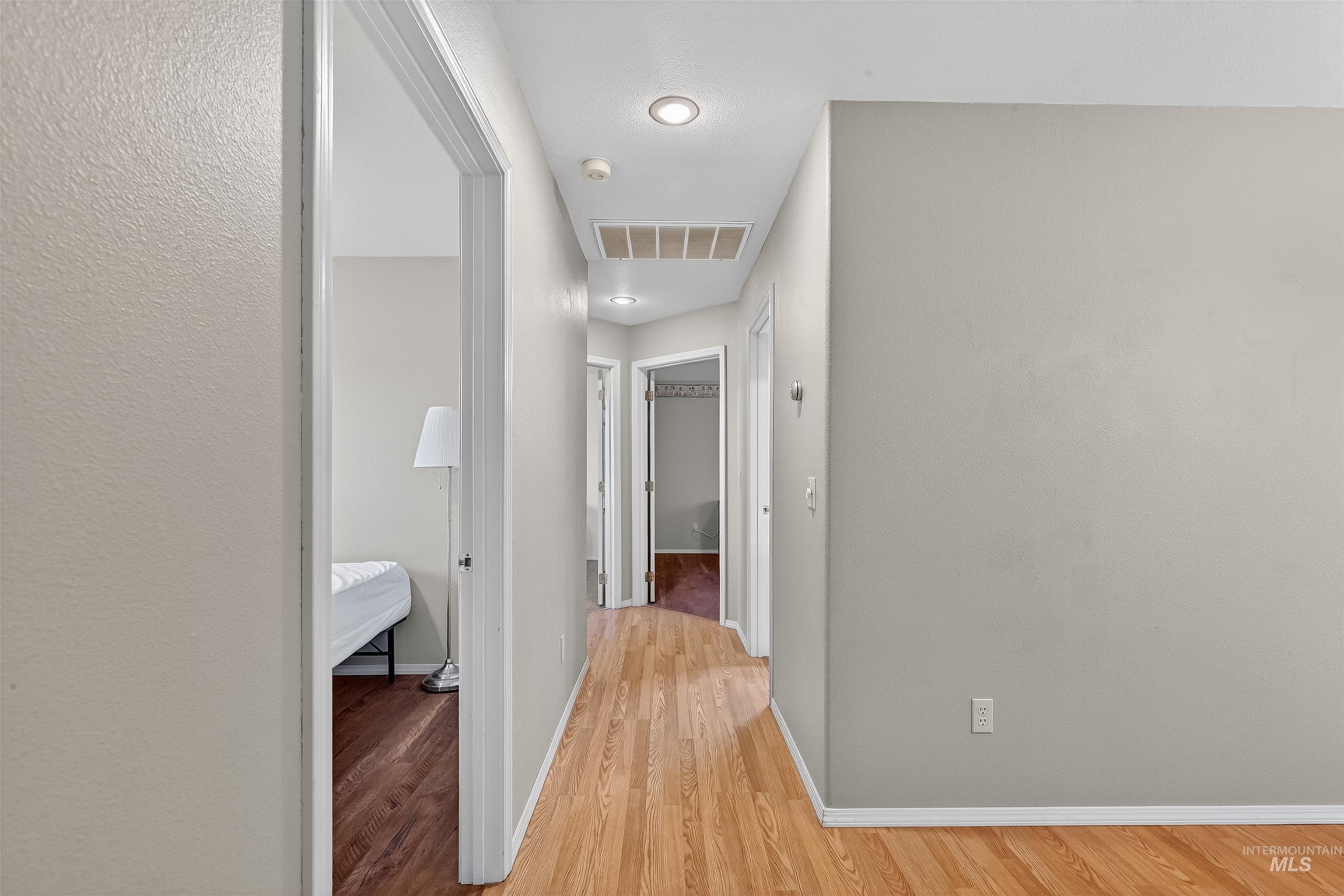 Hallway with light wood finished floors and baseboards