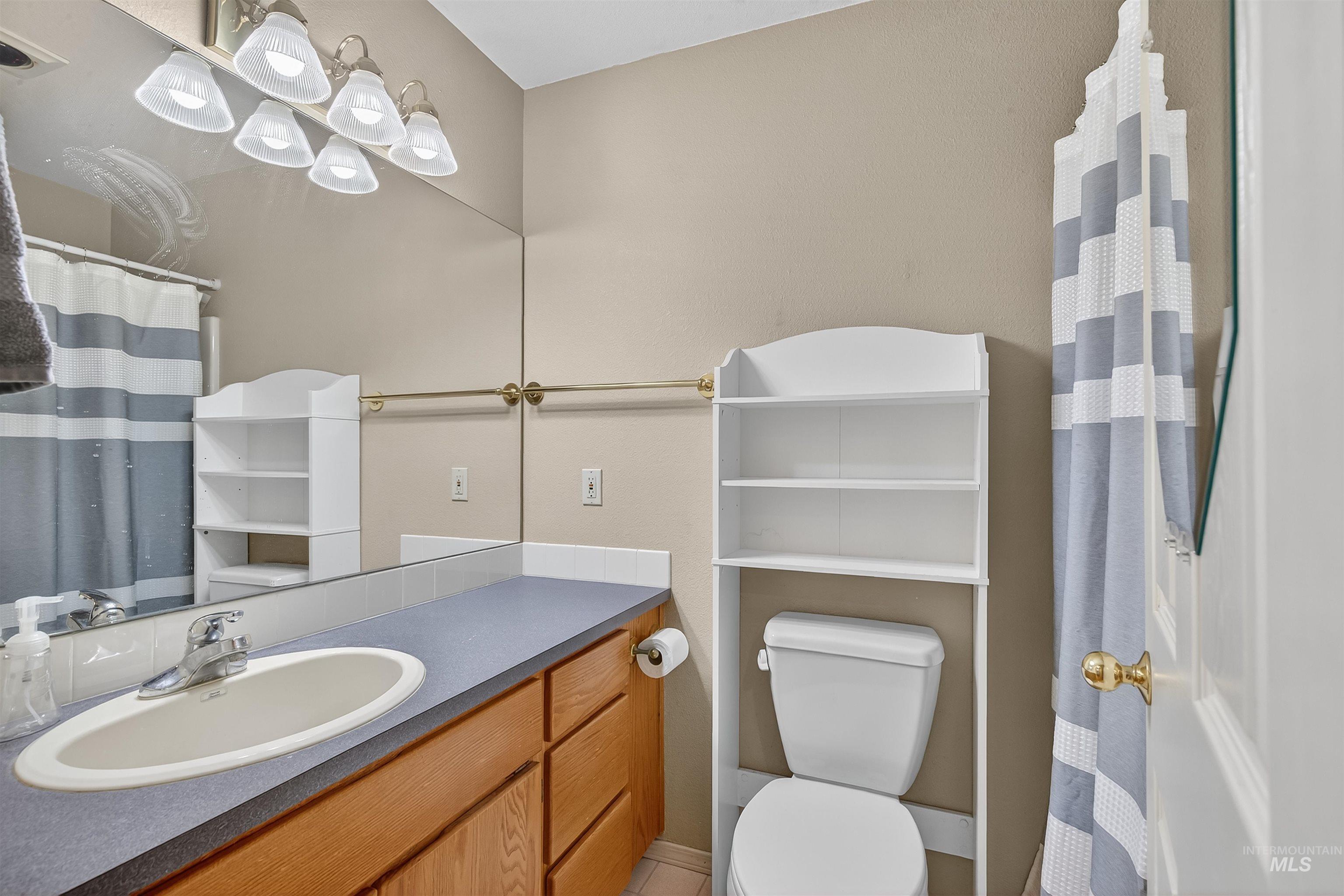 Full bathroom with a shower with curtain and vanity