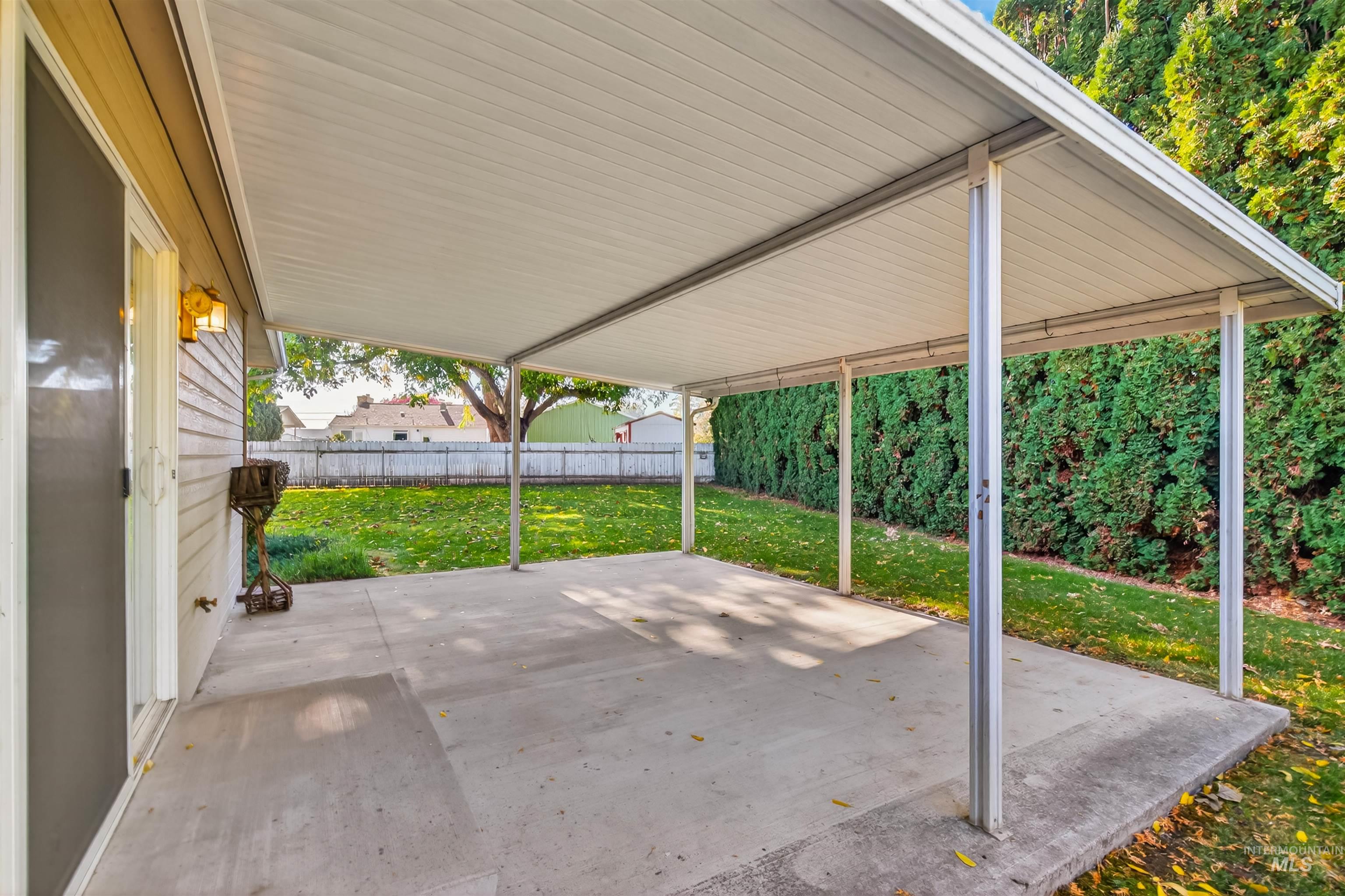 Fenced backyard featuring a patio