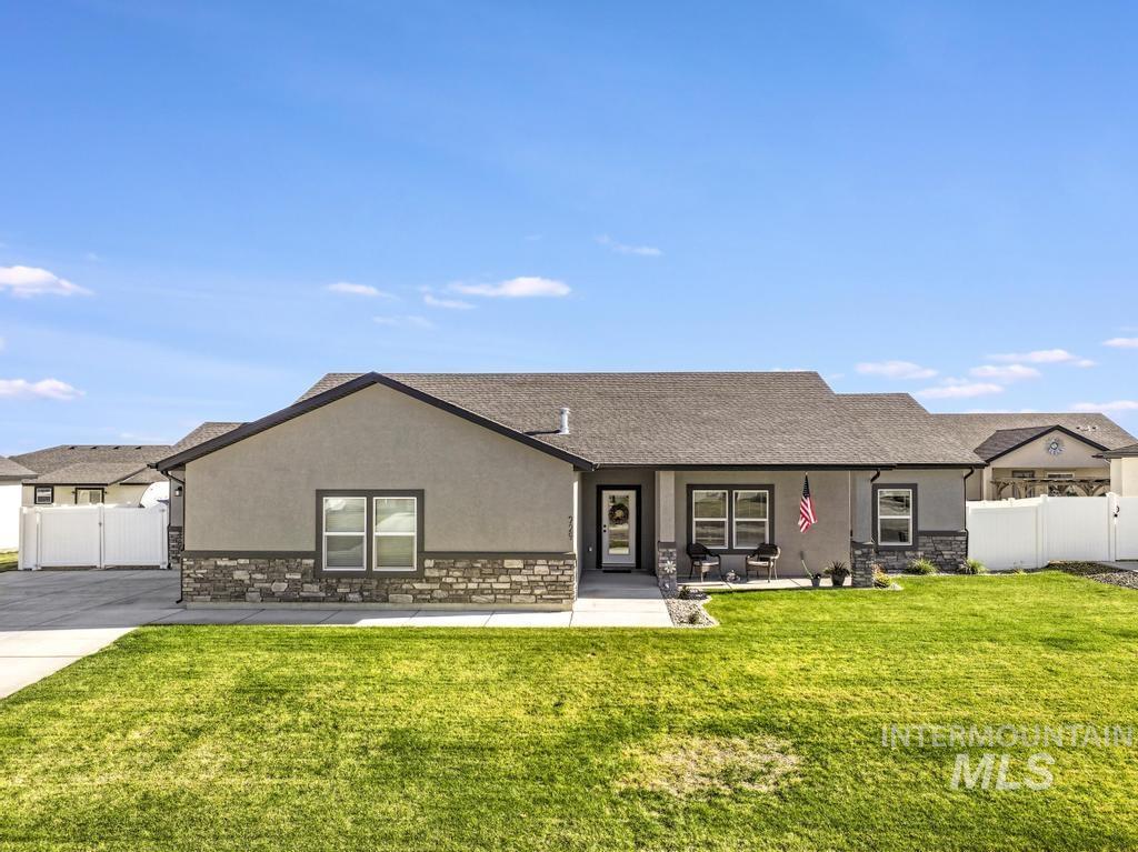 View of front facade featuring stone siding, stucco siding, a porch, and a shingled roof