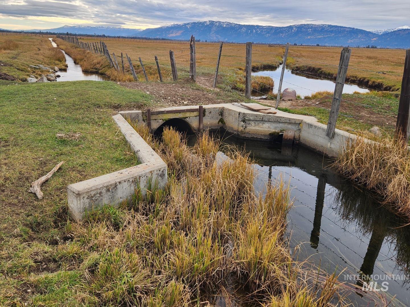 View of community with a rural view and a water and mountain view