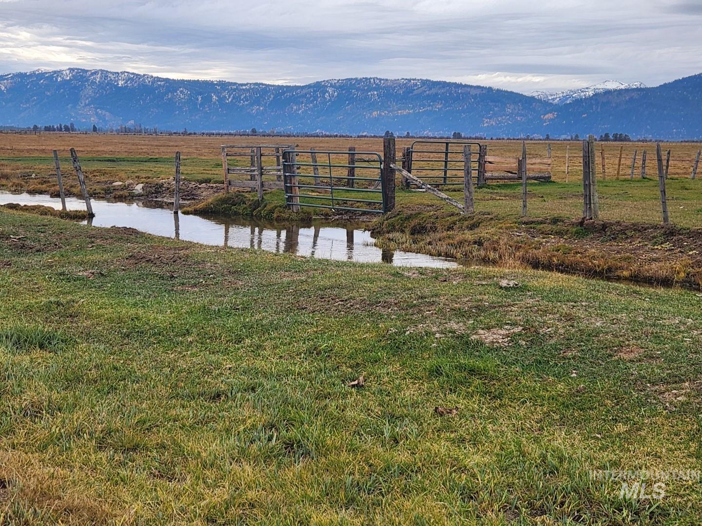 View of yard with a rural view and a water and mountain view