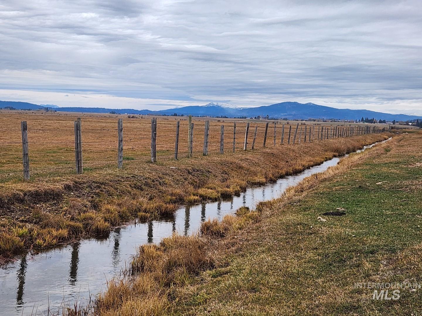 Water view with a mountain backdrop and rural landscape