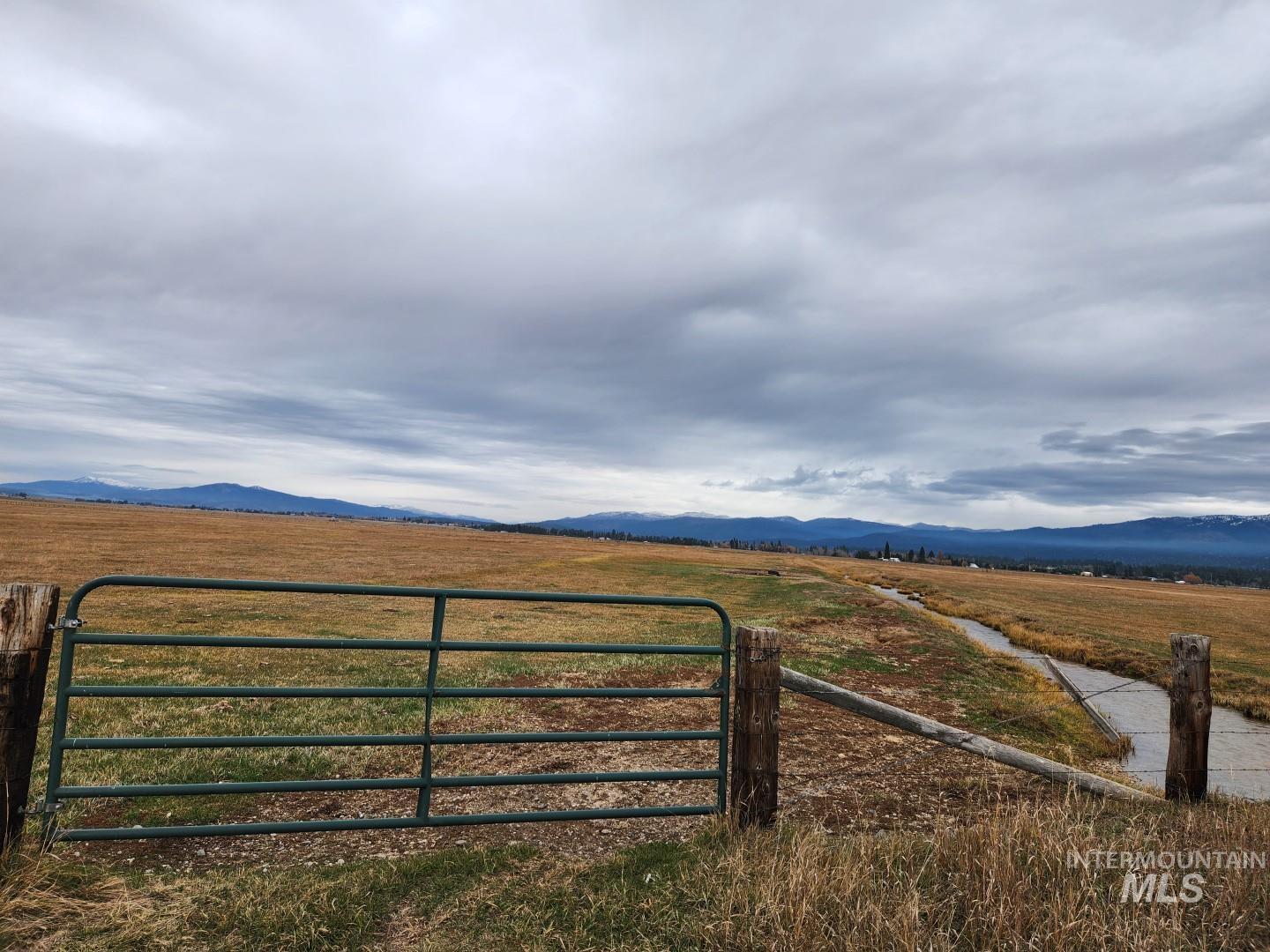 Gate with a view of rural / pastoral area and a mountain view