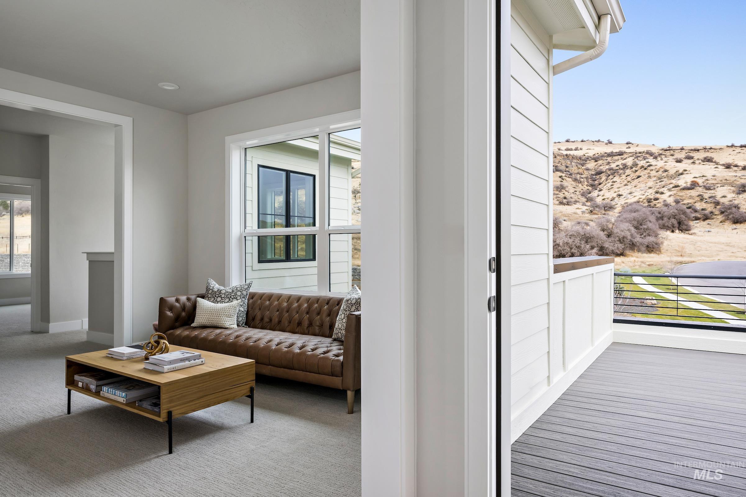 Carpeted living area with baseboards