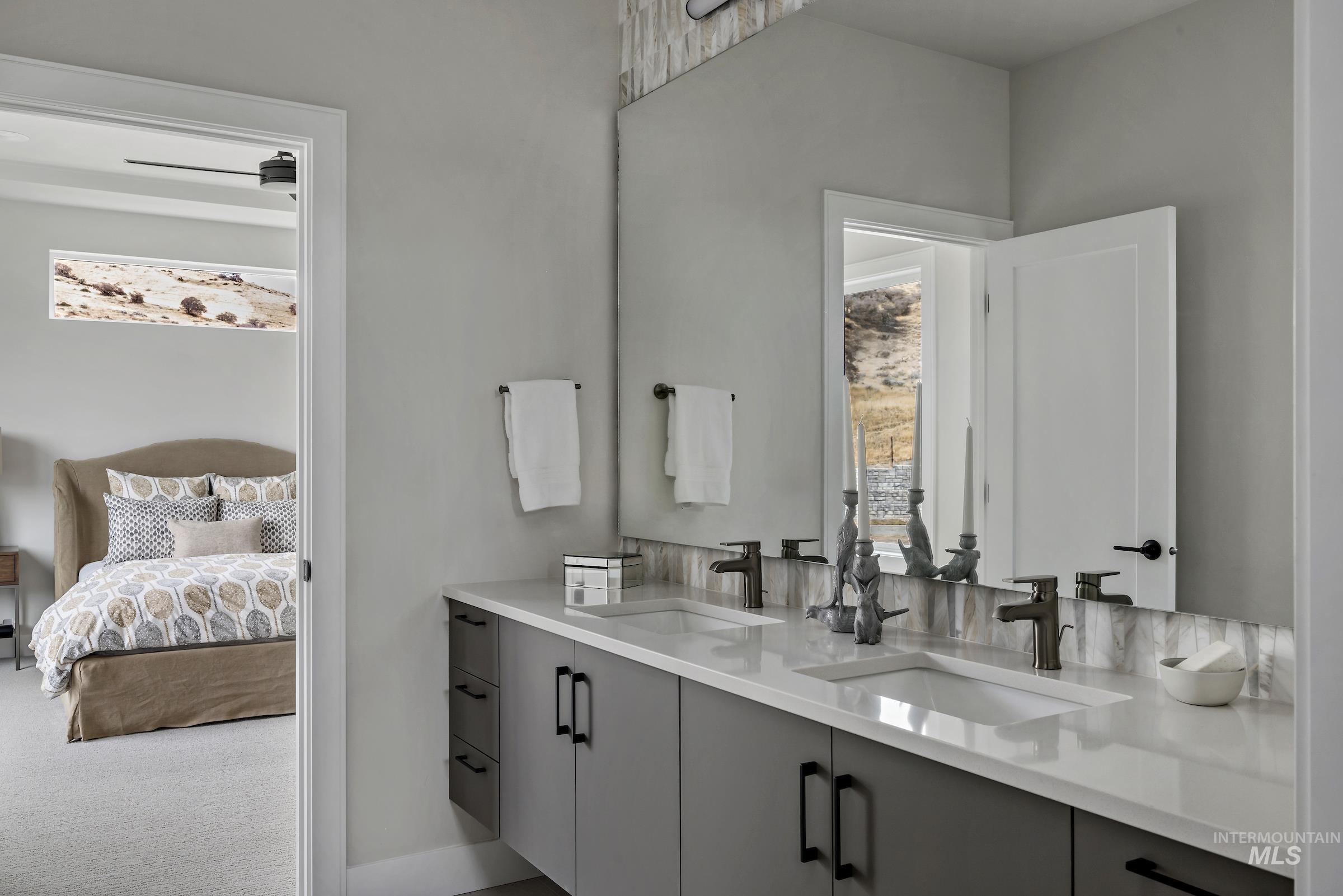 Bathroom with double vanity, ensuite bath, and carpet flooring