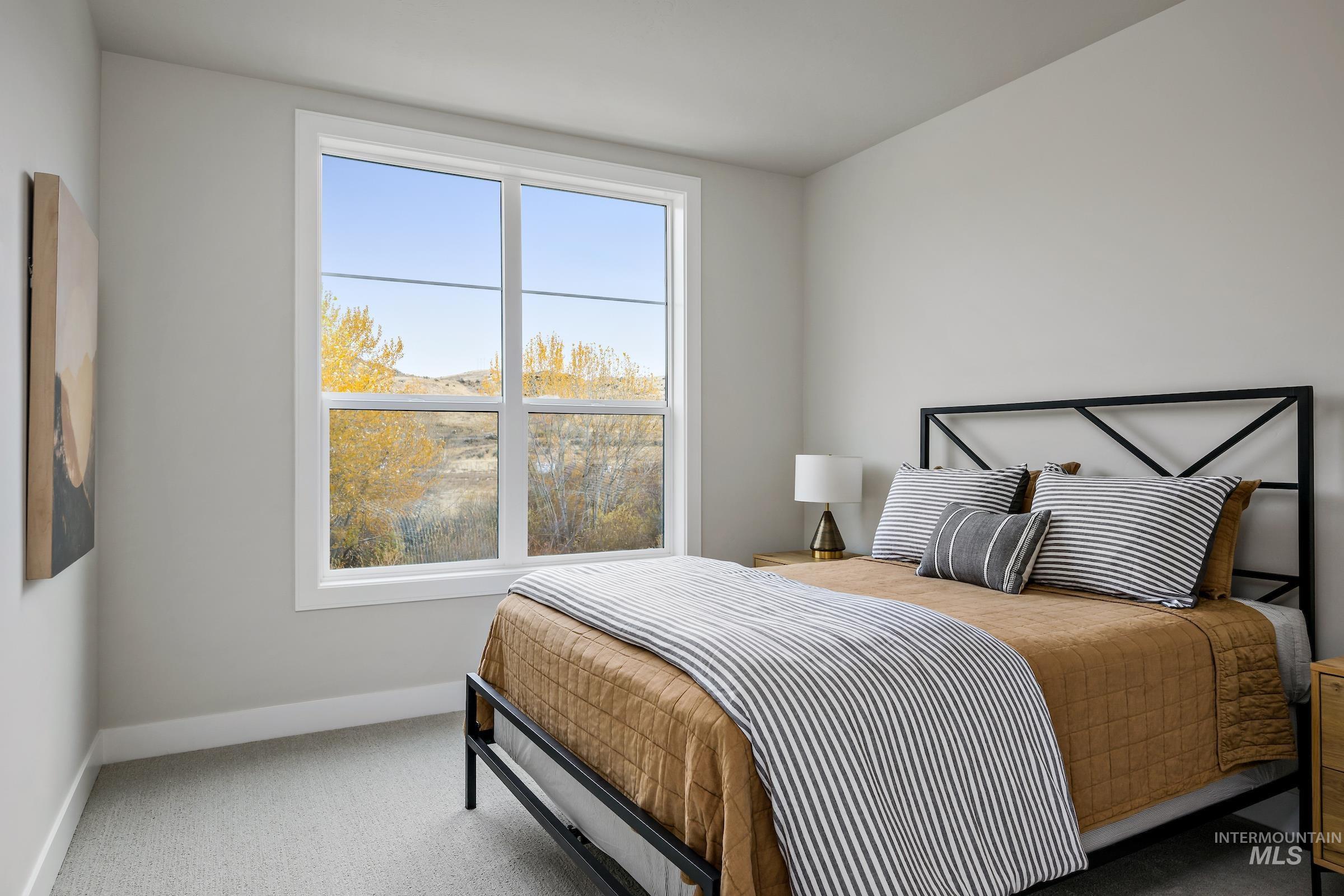 Carpeted bedroom featuring baseboards