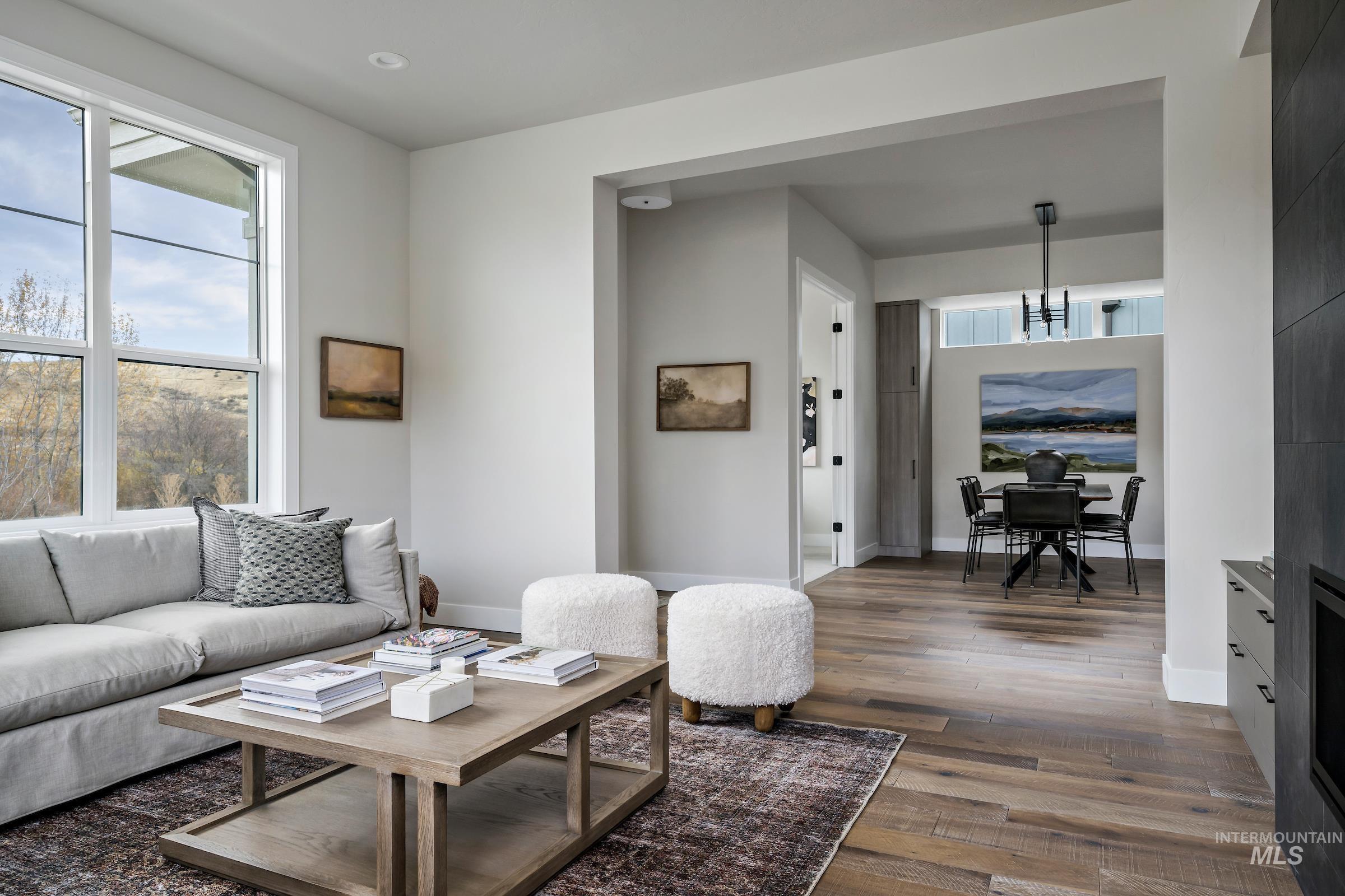 Living area with dark wood finished floors and baseboards
