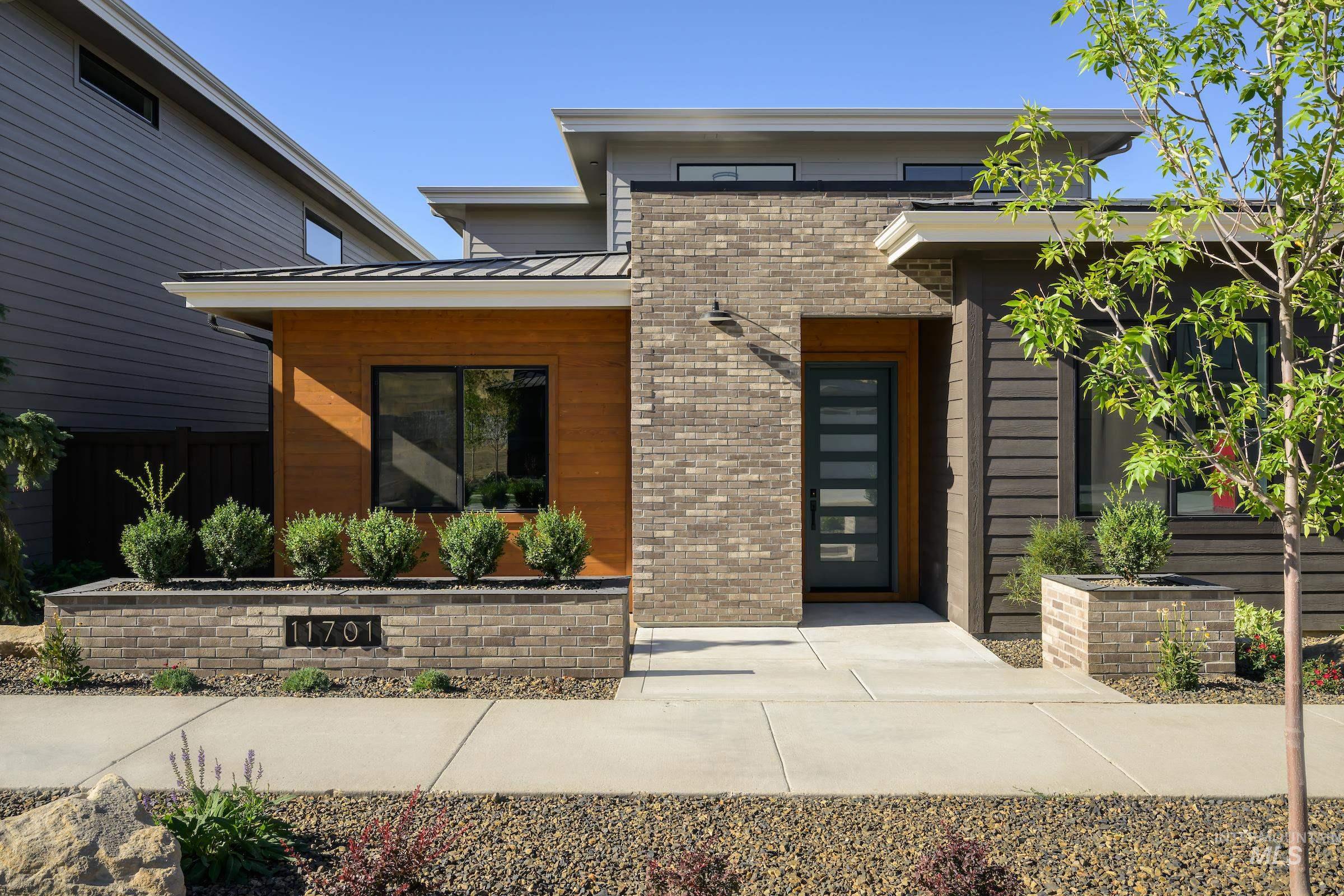 View of exterior entry featuring a standing seam roof, a metal roof, and brick siding