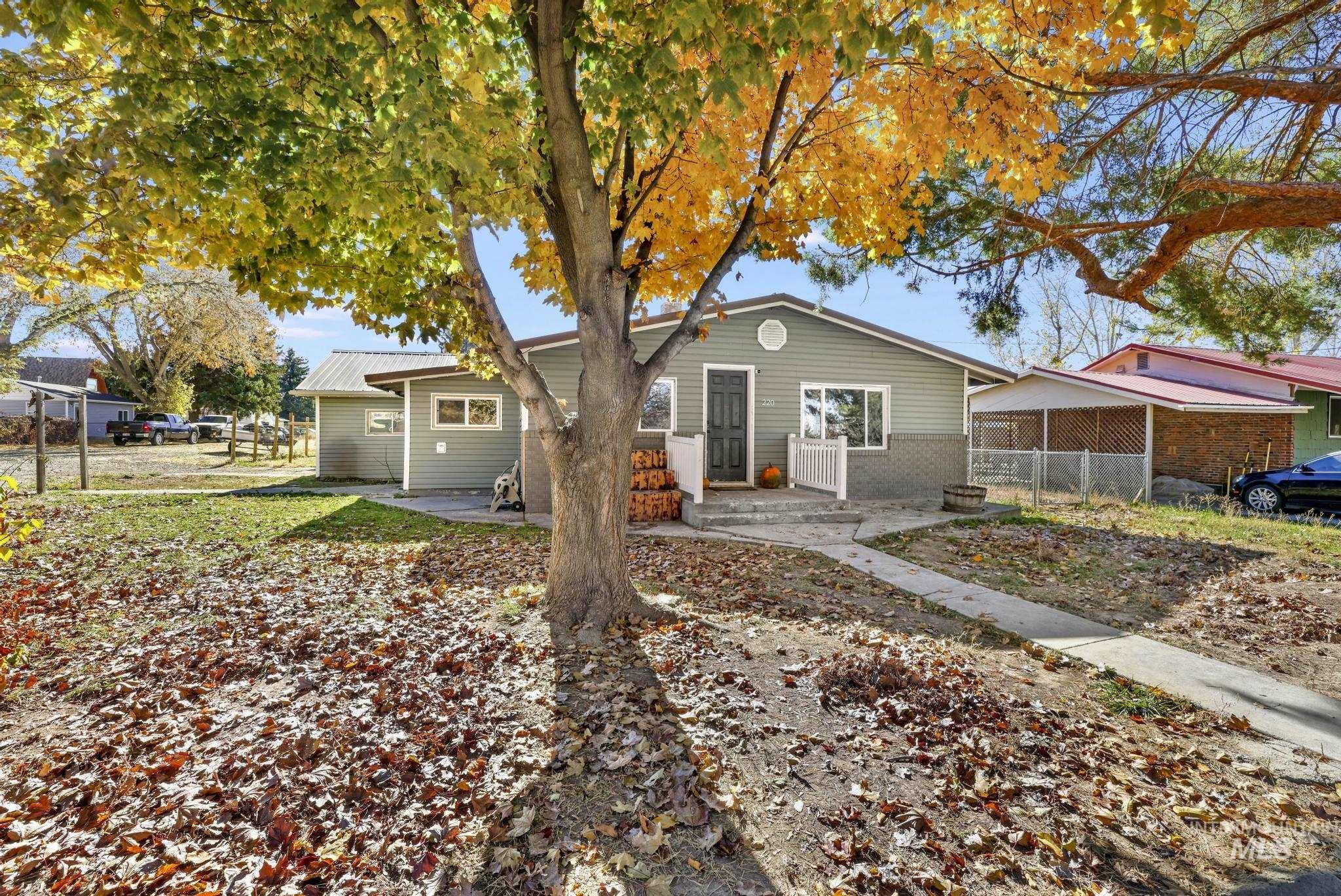 Bungalow-style home featuring a patio area, a metal roof, and brick siding