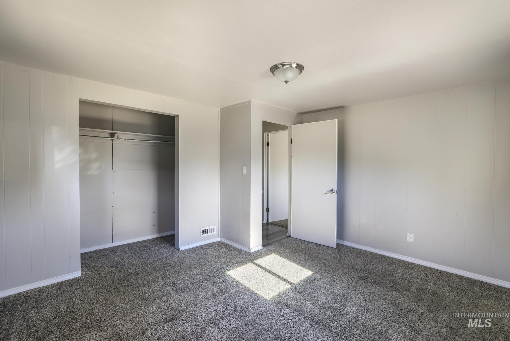Unfurnished bedroom featuring a closet and carpet floors