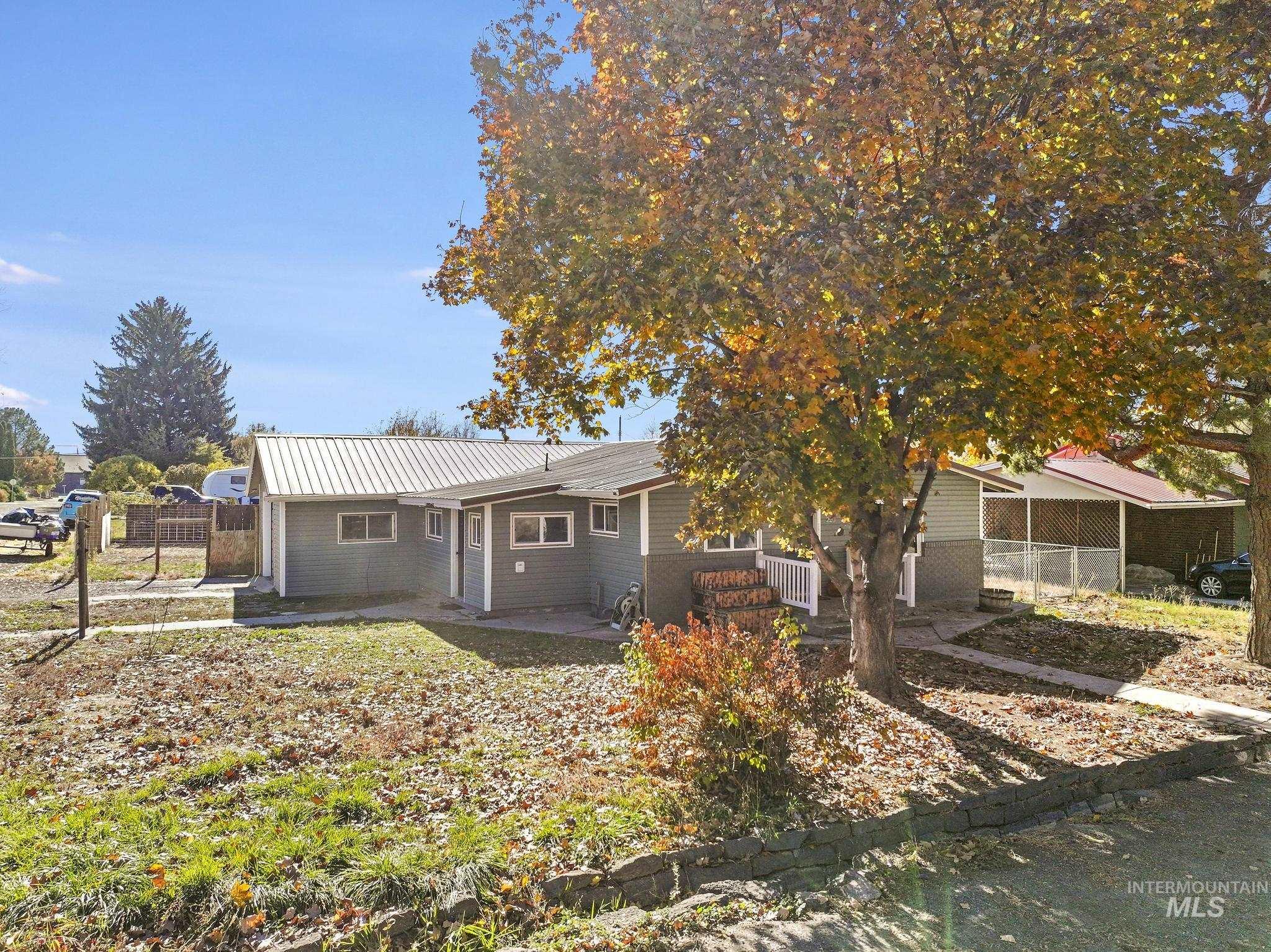 View of front of property with a metal roof and a patio area