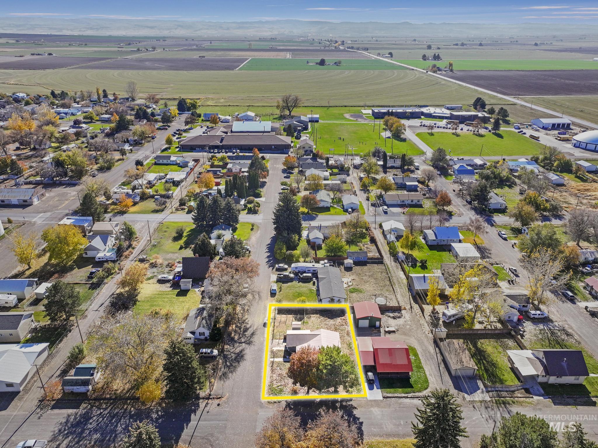 Aerial view of residential area with property parcel outlined