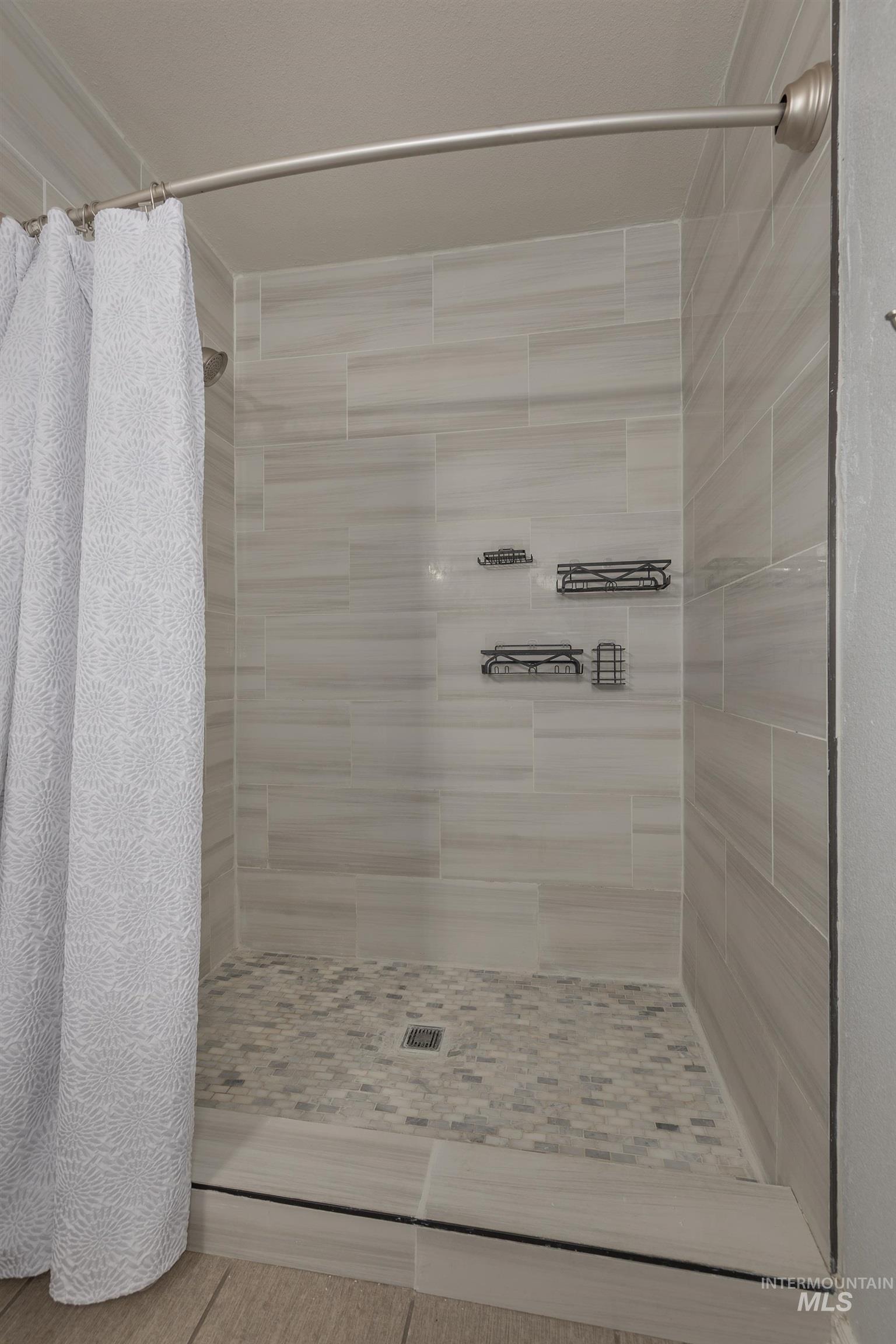 Full bath with a tile shower