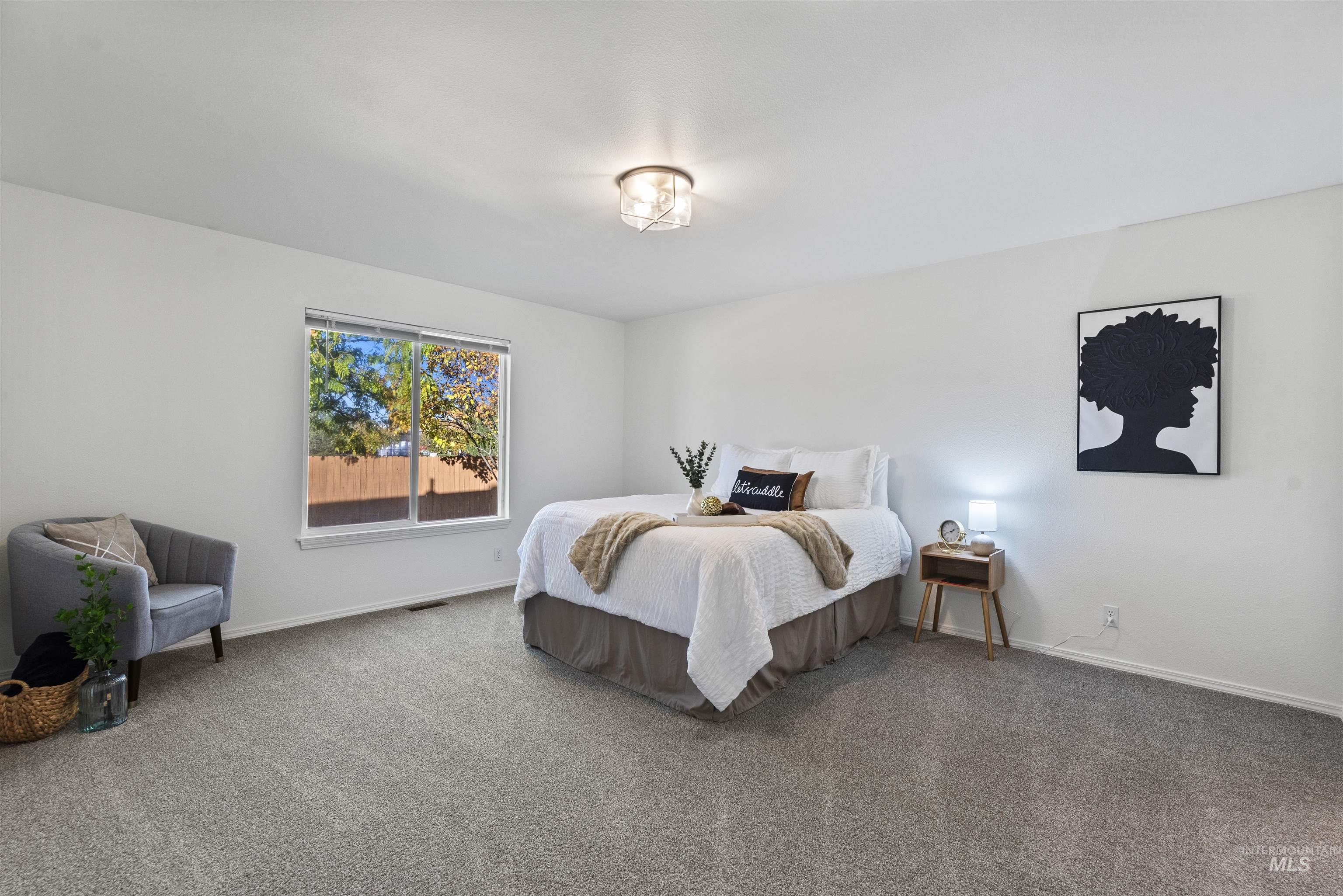 Carpeted bedroom with baseboards