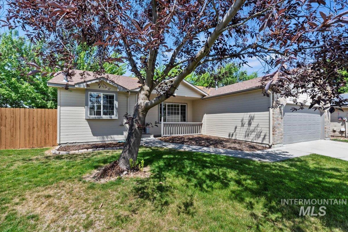 Ranch-style house with a garage and driveway