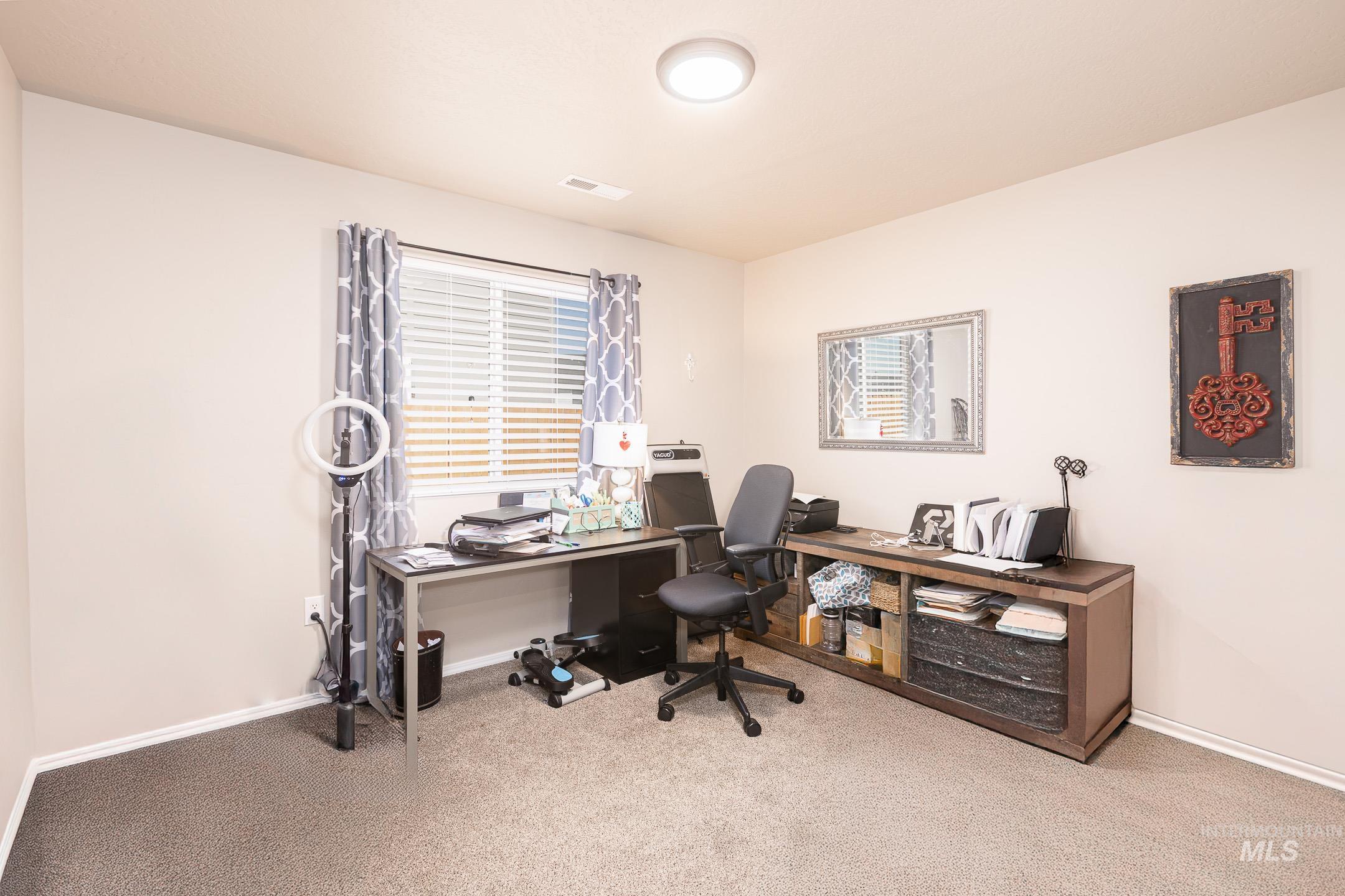Office space with carpet and baseboards