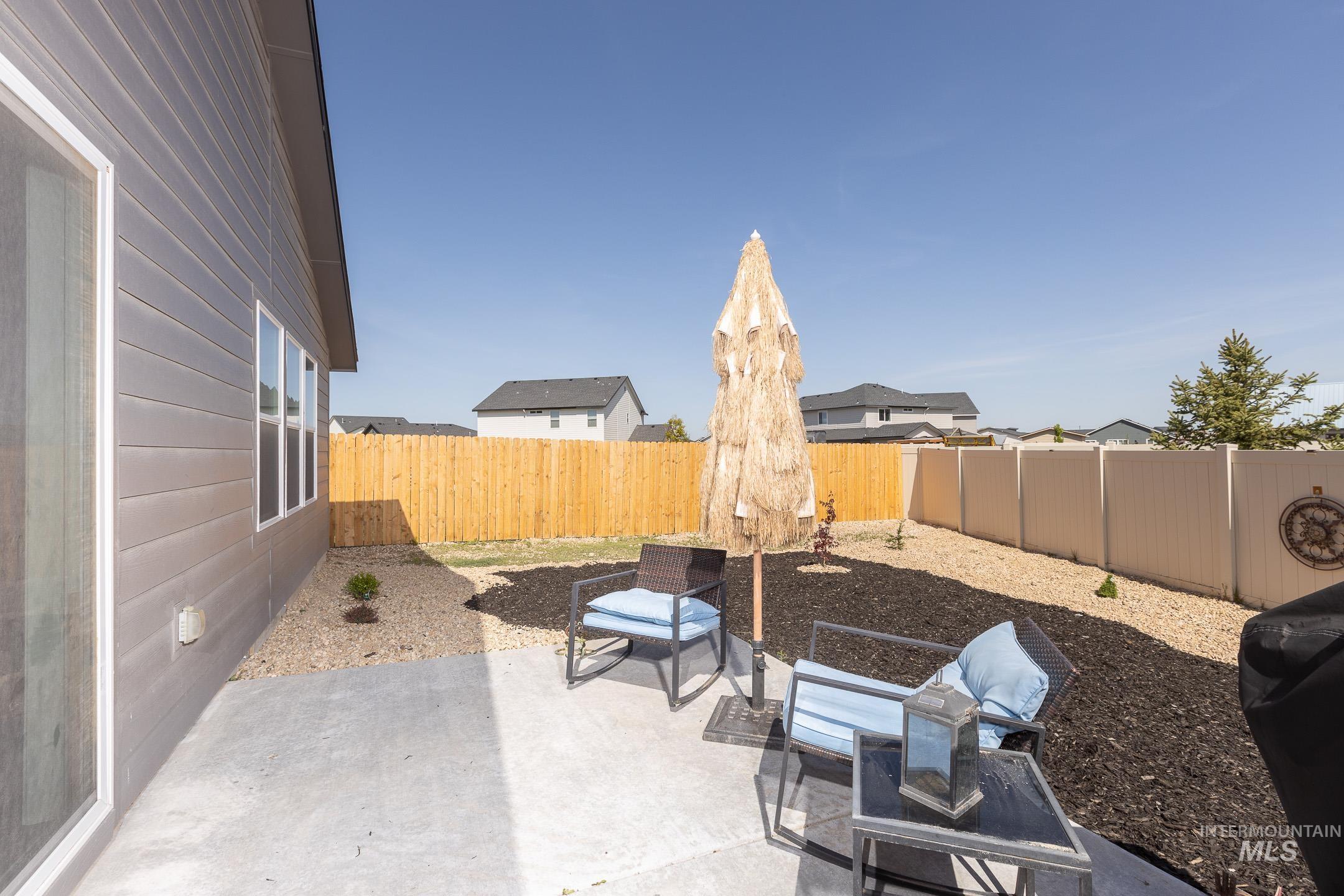 Fenced backyard with a patio