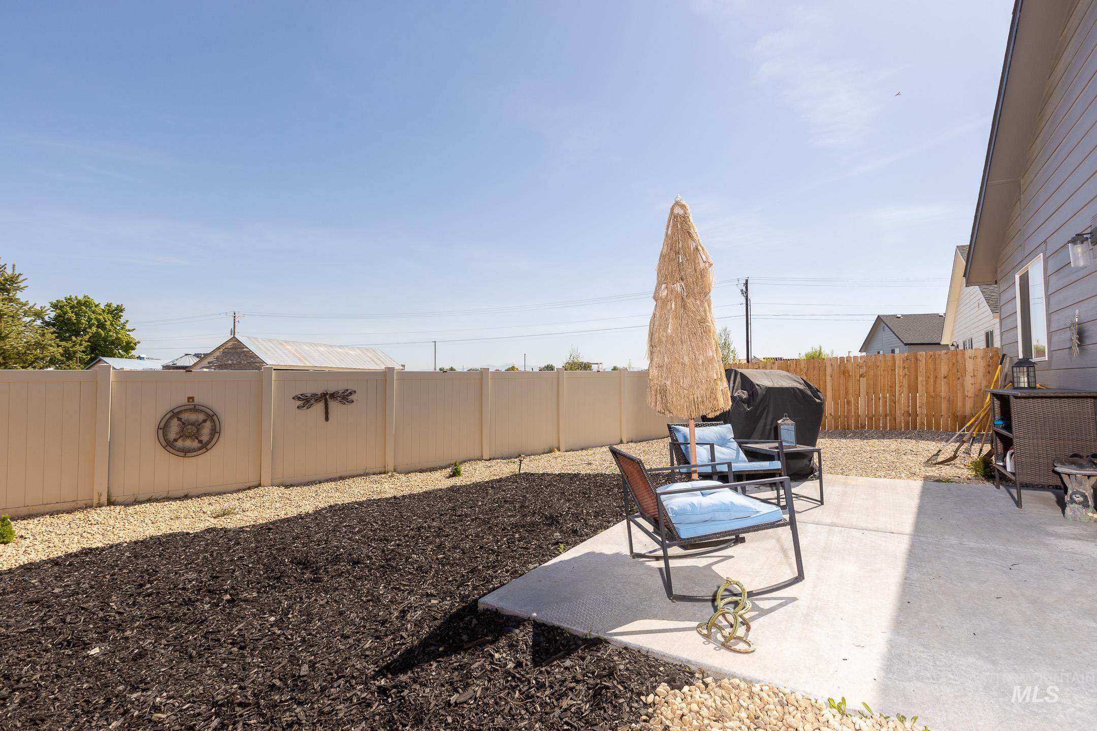 Fenced backyard featuring a patio
