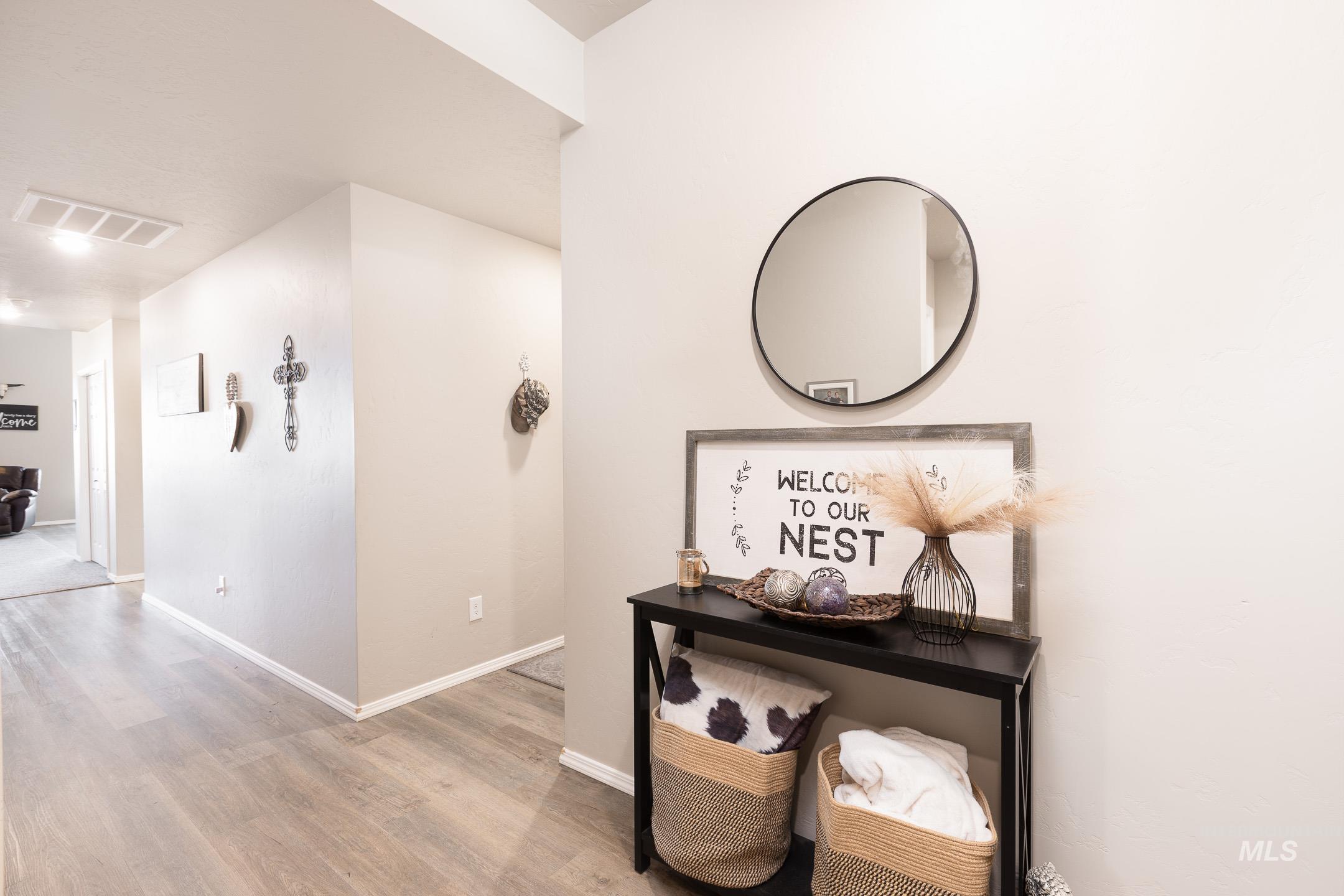 Hallway with wood finished floors and baseboards