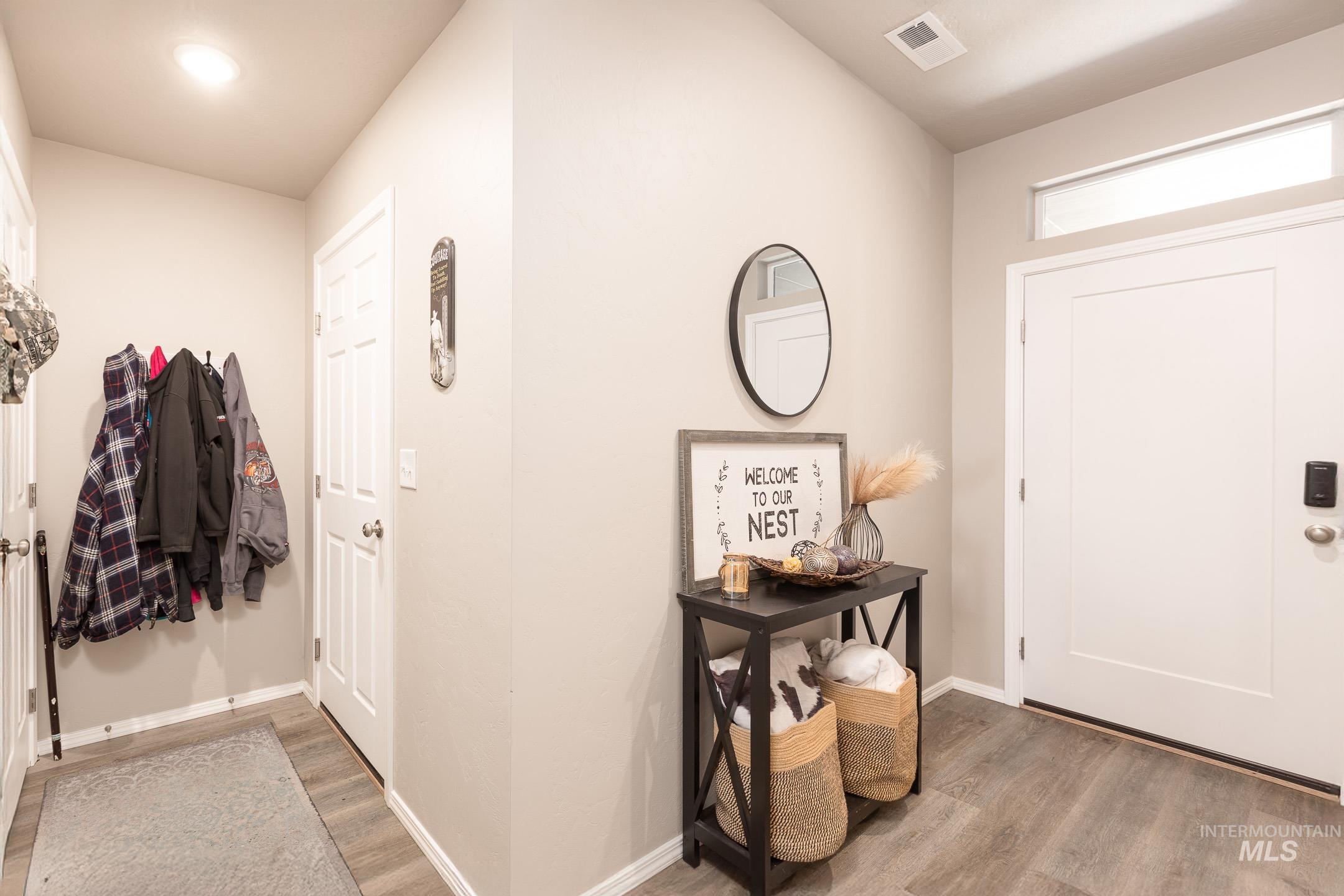 Foyer featuring light wood-type flooring and baseboards