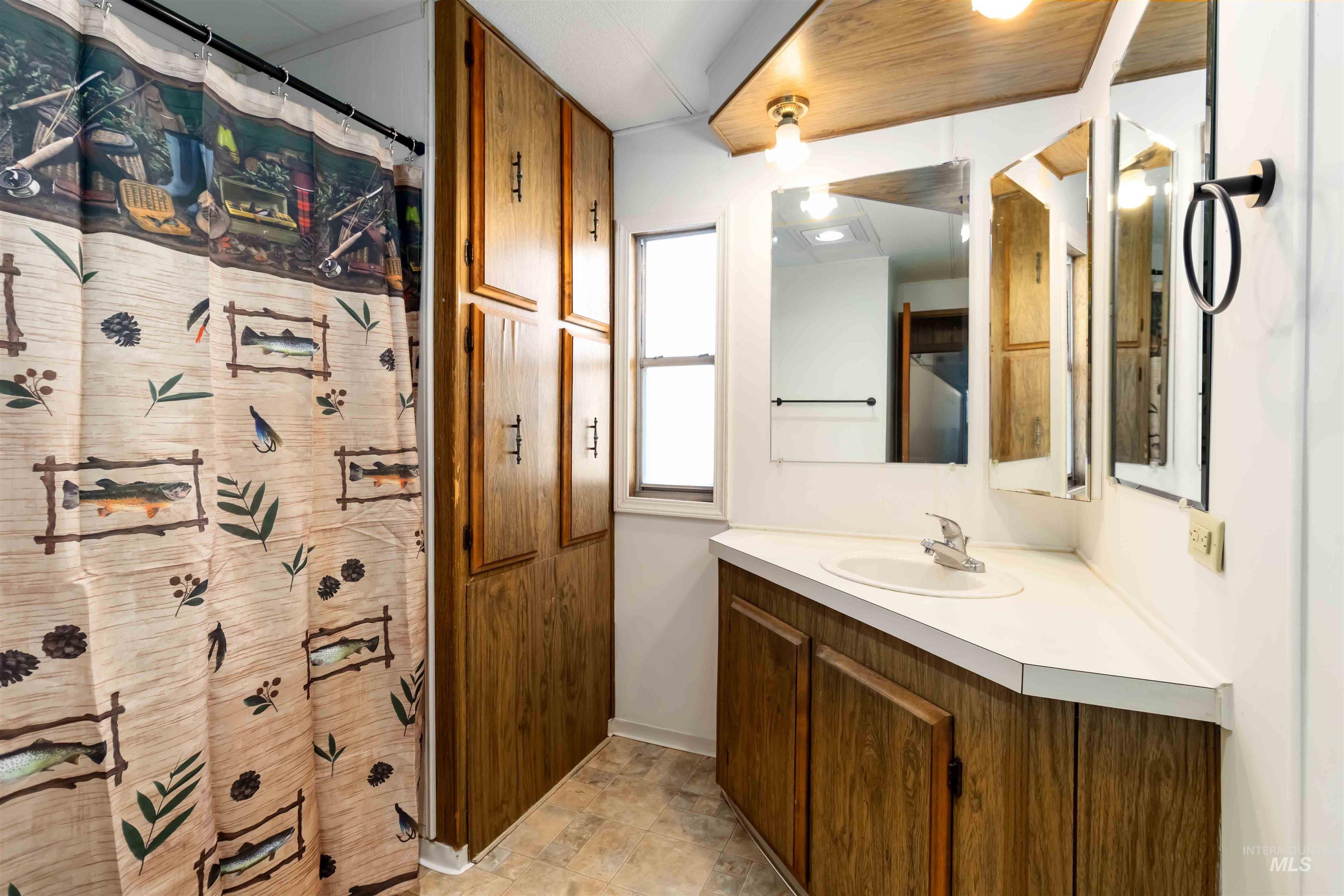 Bathroom with vanity and a shower with curtain