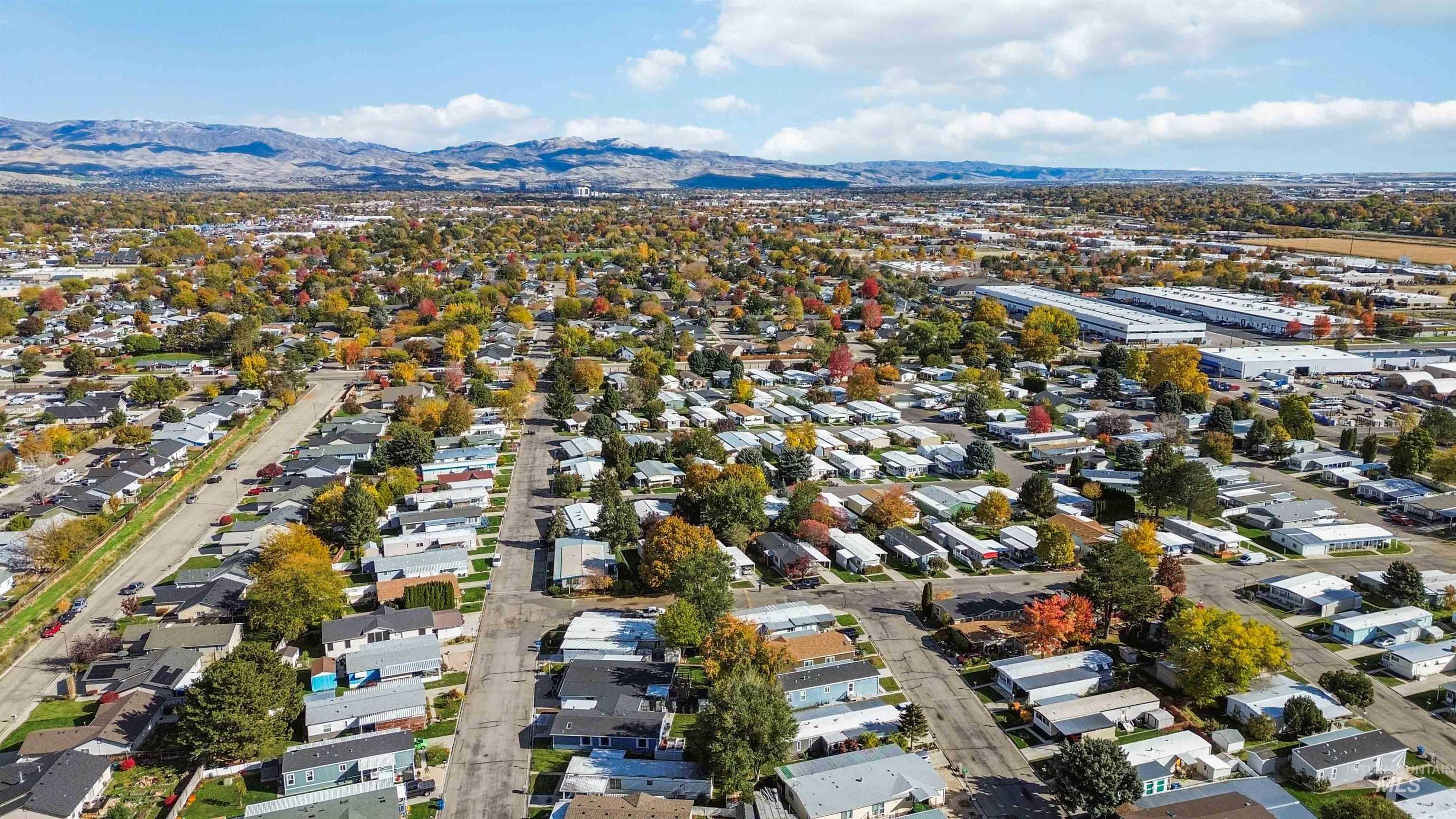 Aerial view of property's location with a mountain backdrop and nearby suburban area