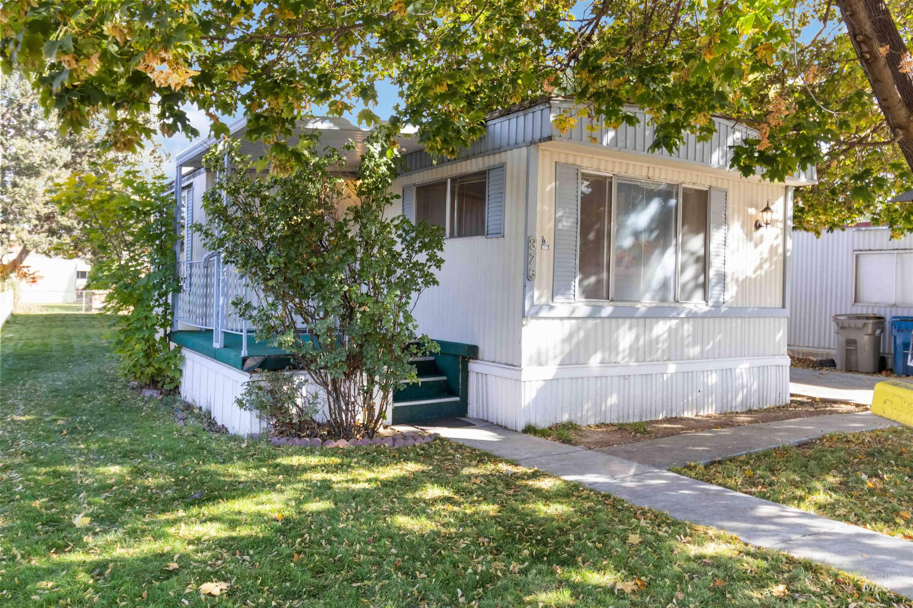 View of property exterior with a lawn