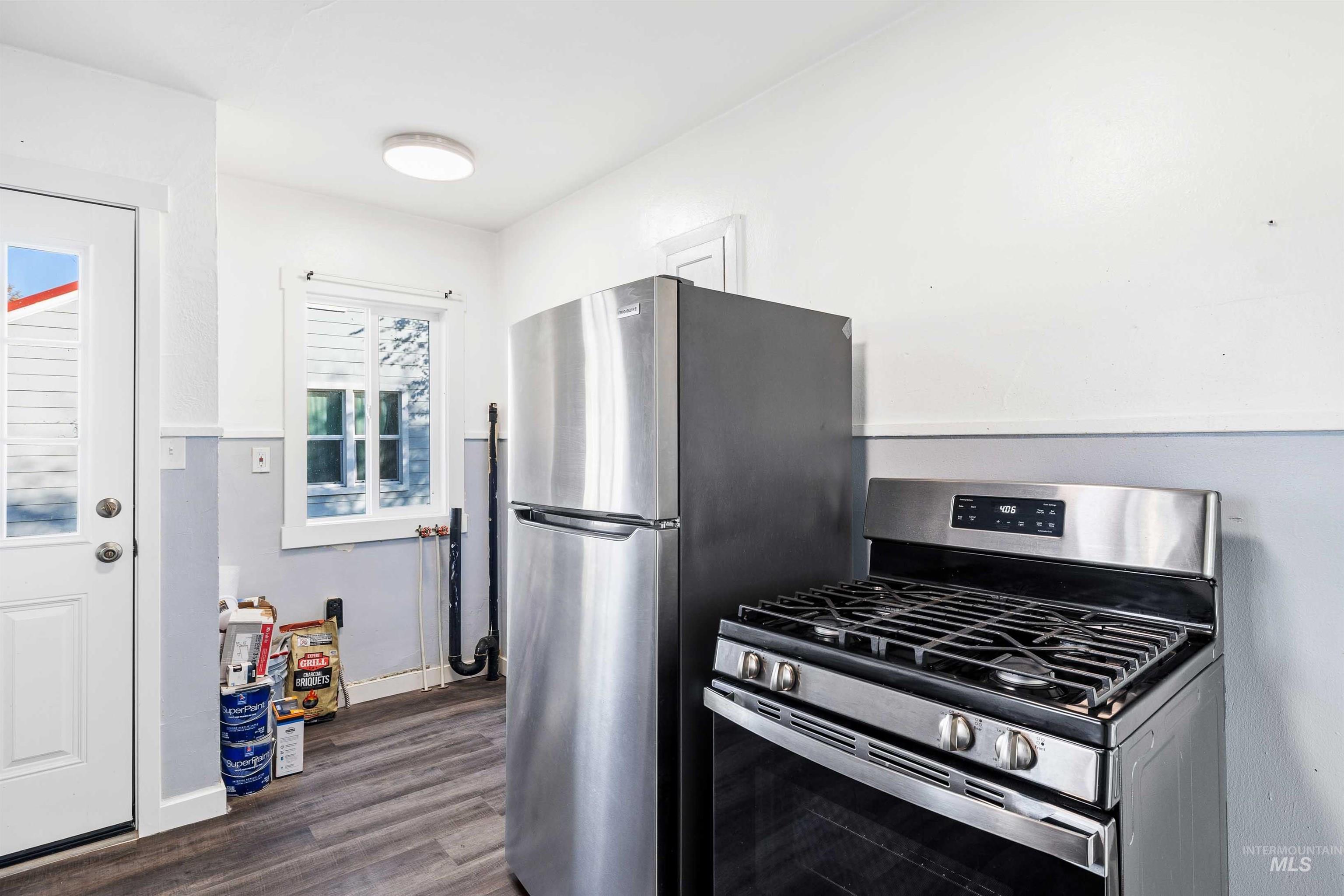 Kitchen featuring stainless steel gas range and dark wood finished floors