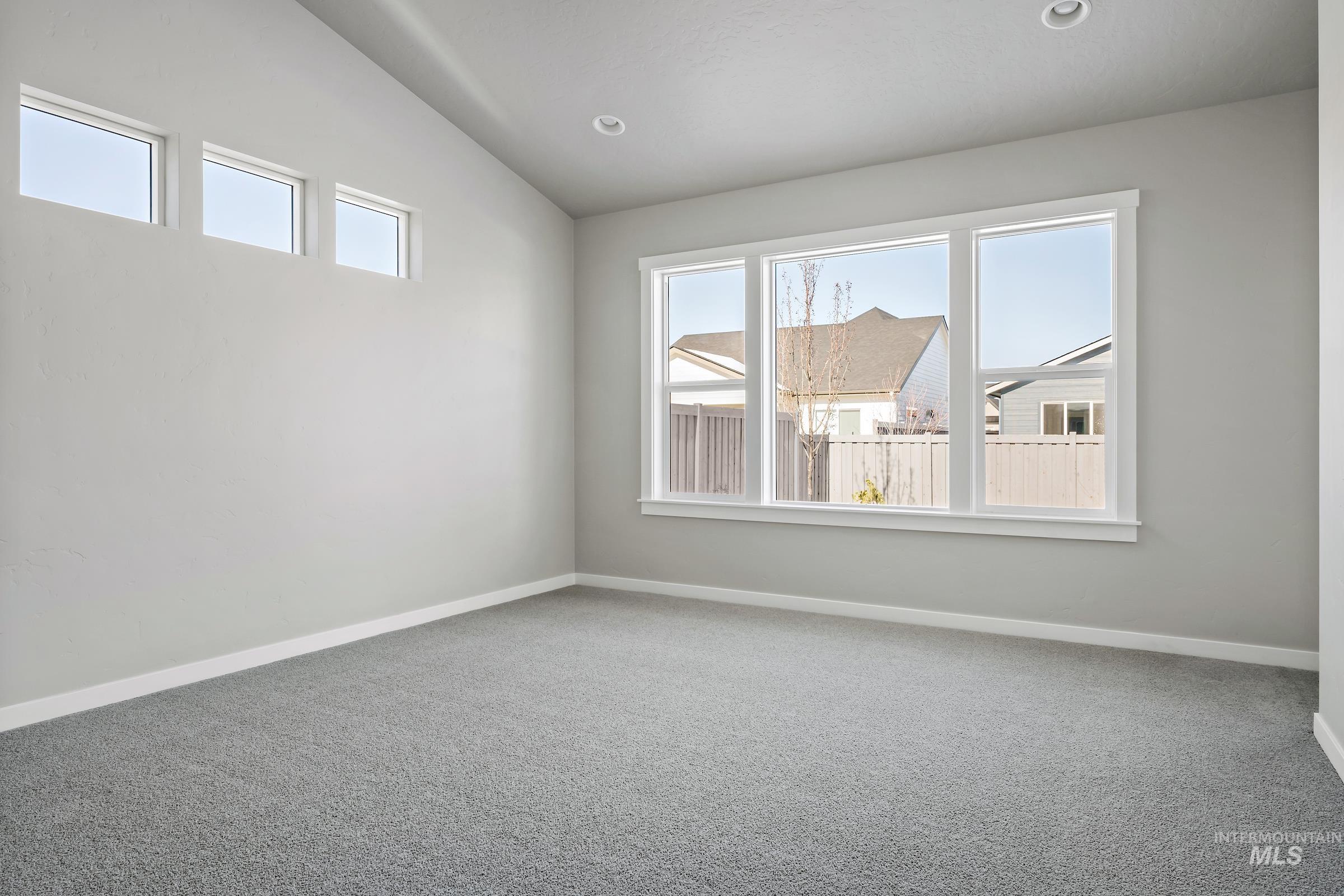 Unfurnished room with carpet, vaulted ceiling, and recessed lighting