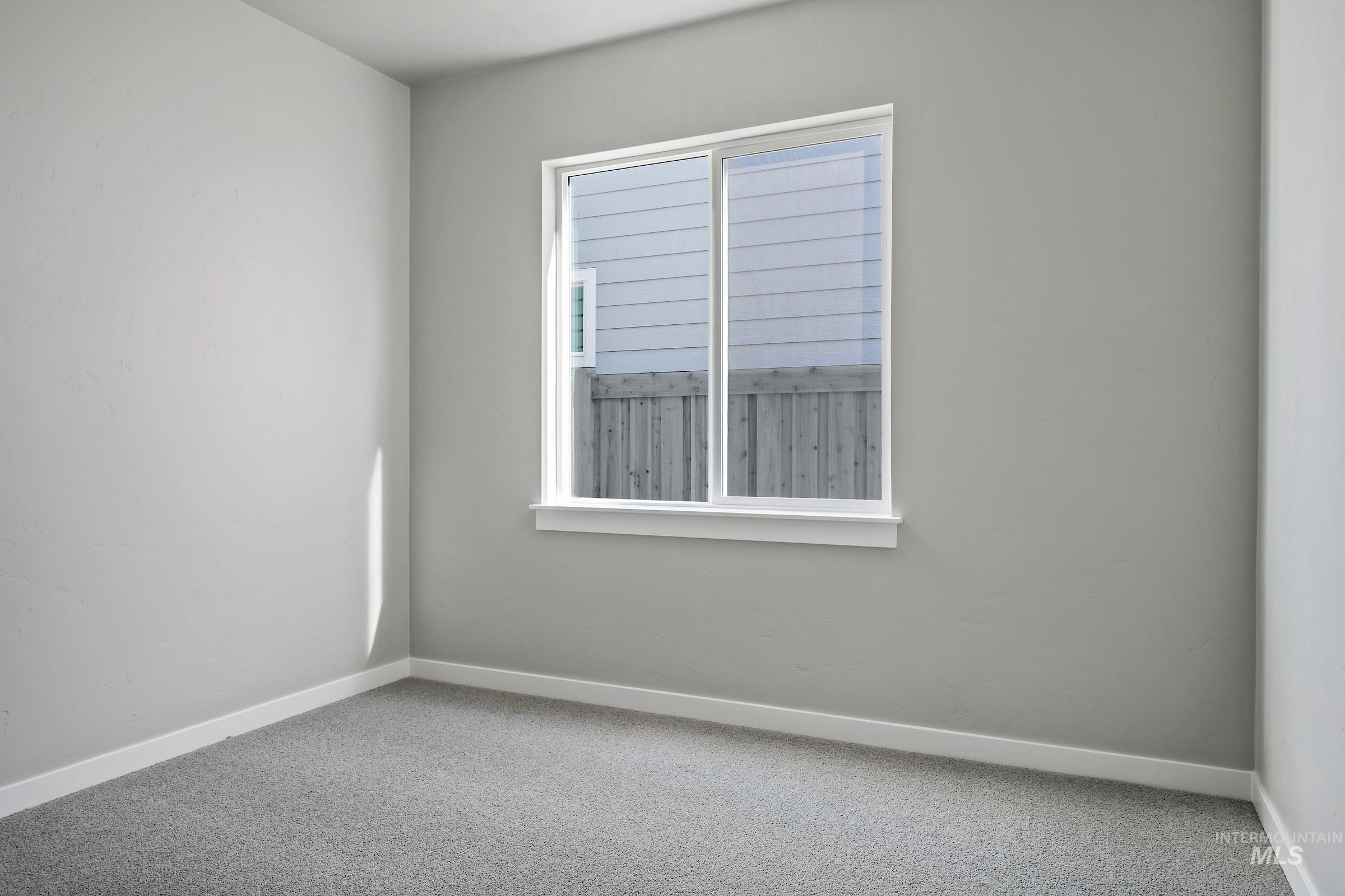 Spare room featuring carpet flooring