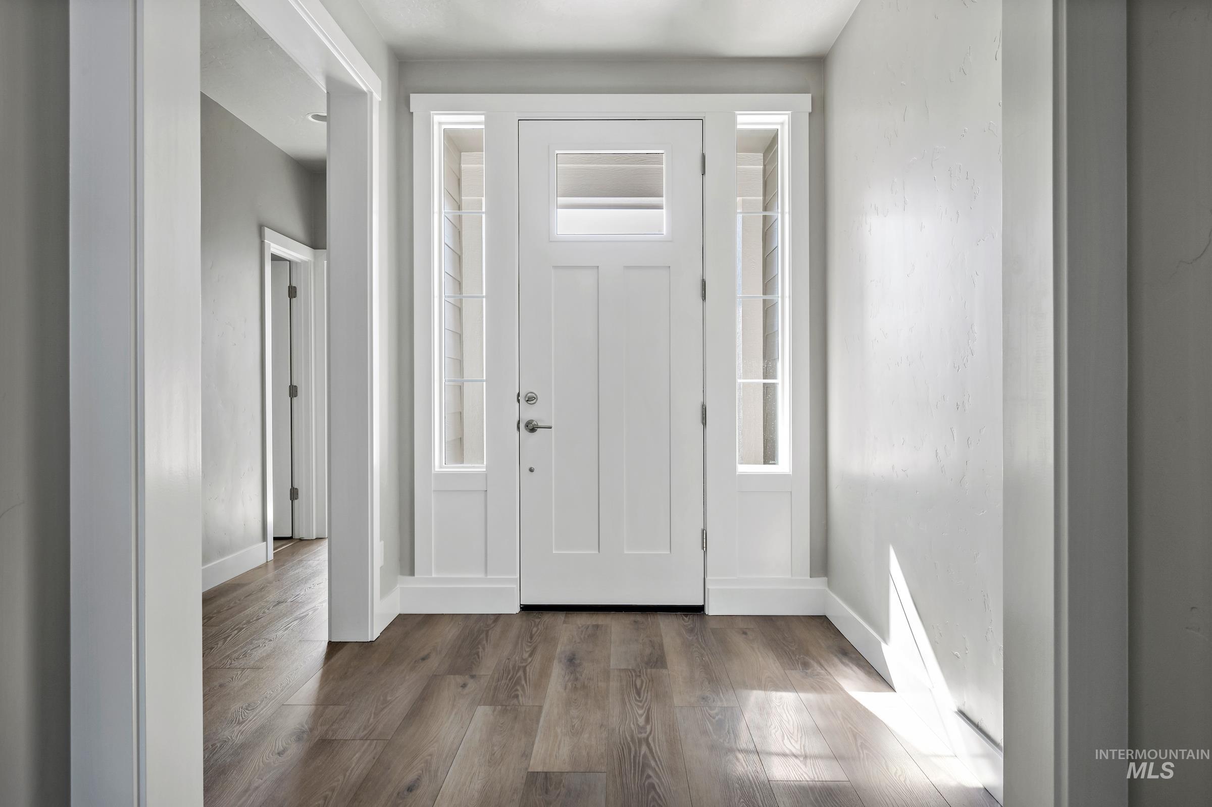 Entrance foyer featuring wood finished floors and baseboards