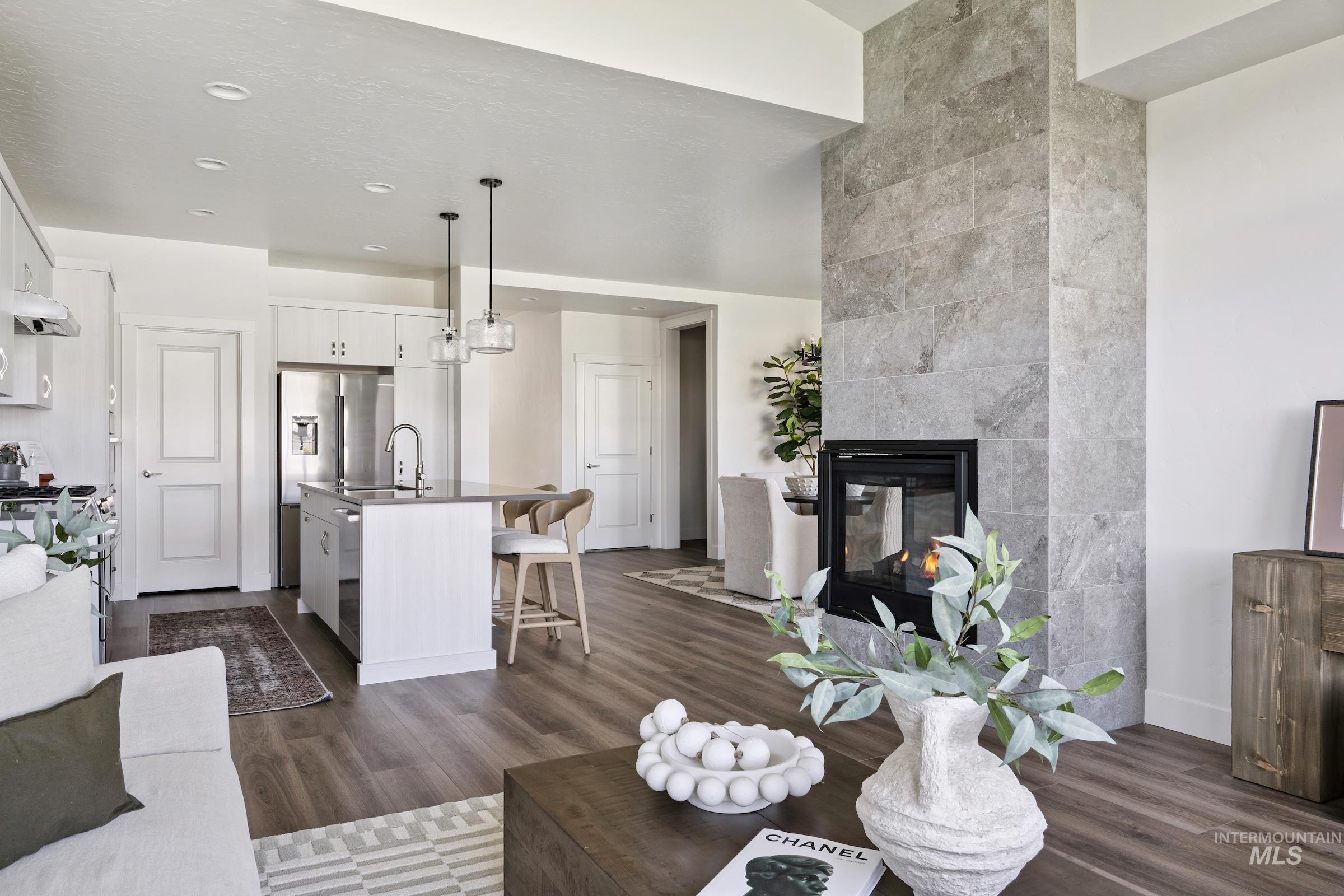 Living room featuring a tile fireplace, dark wood finished floors, and recessed lighting