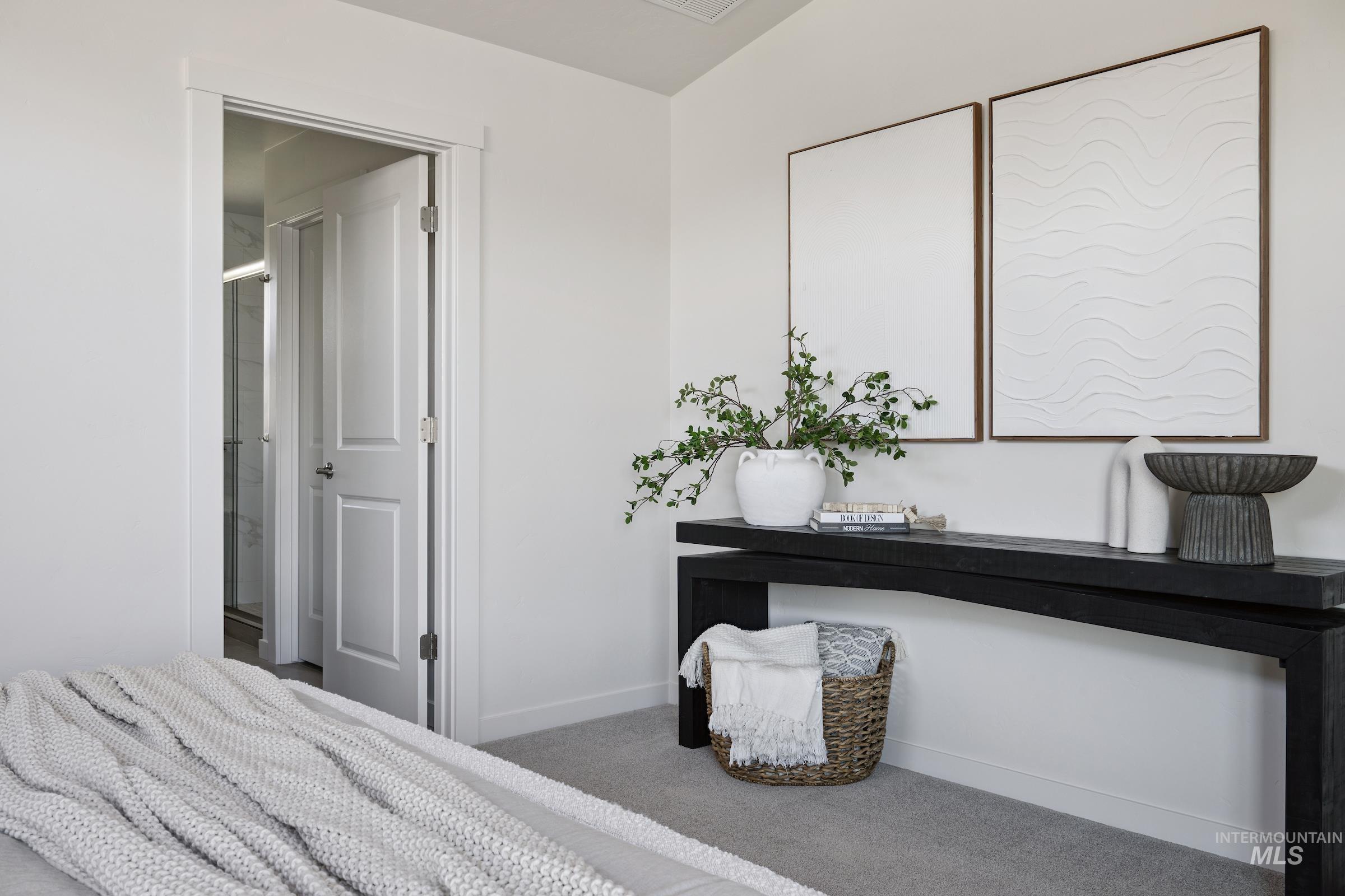 Bedroom featuring baseboards and carpet