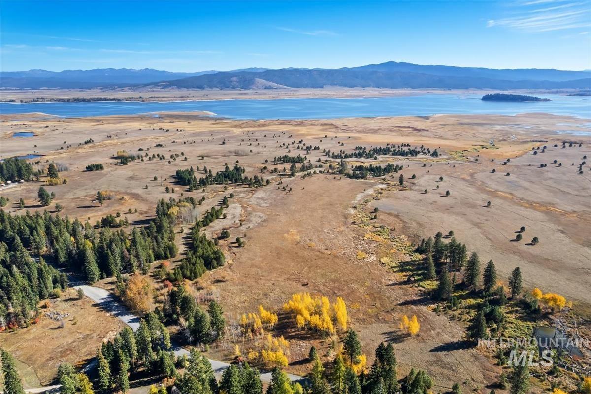 Aerial view of property's location featuring a water and mountain view