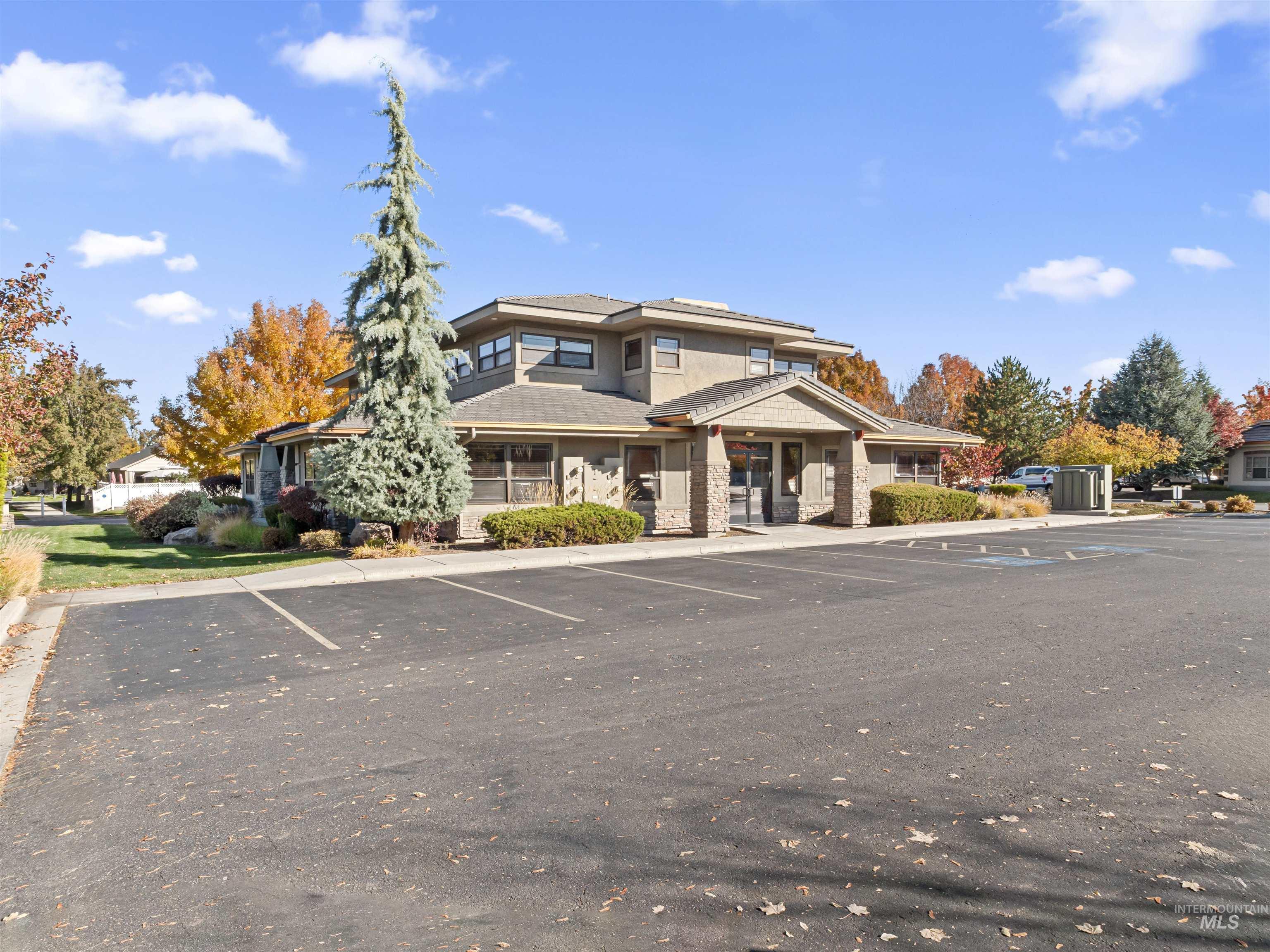 View of building exterior featuring uncovered parking