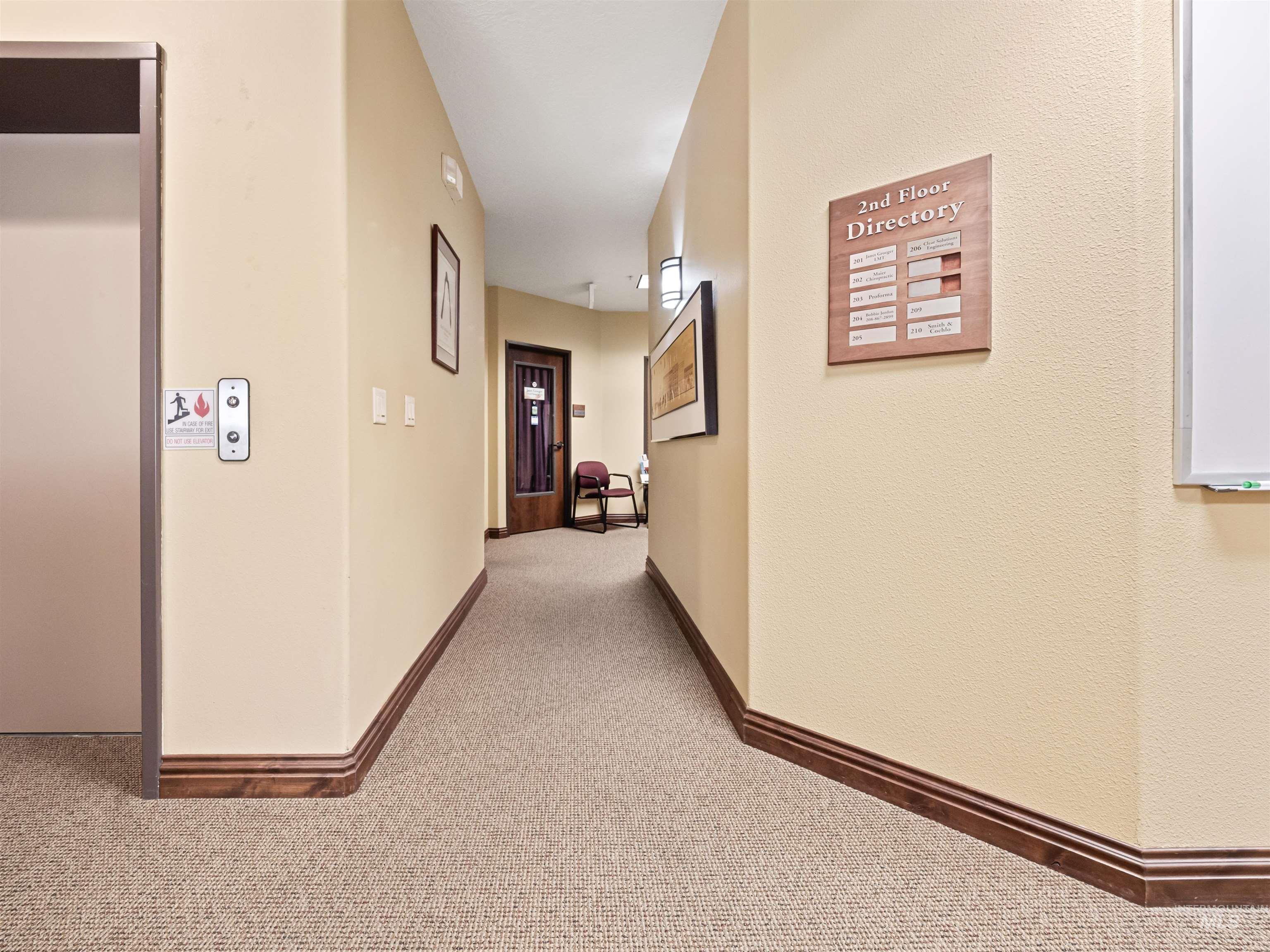 Hall with carpet floors and elevator