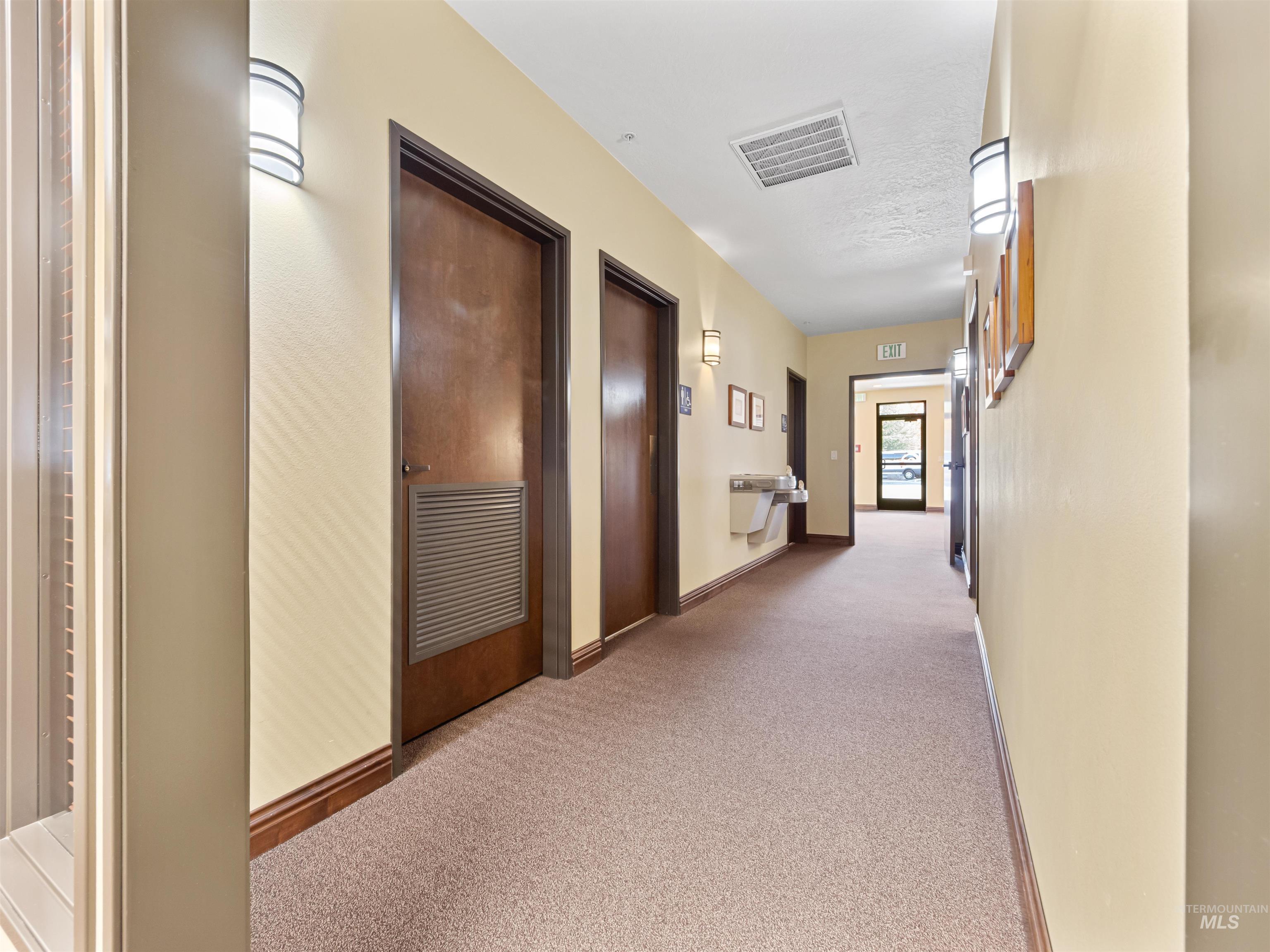 Hall with light carpet and baseboards