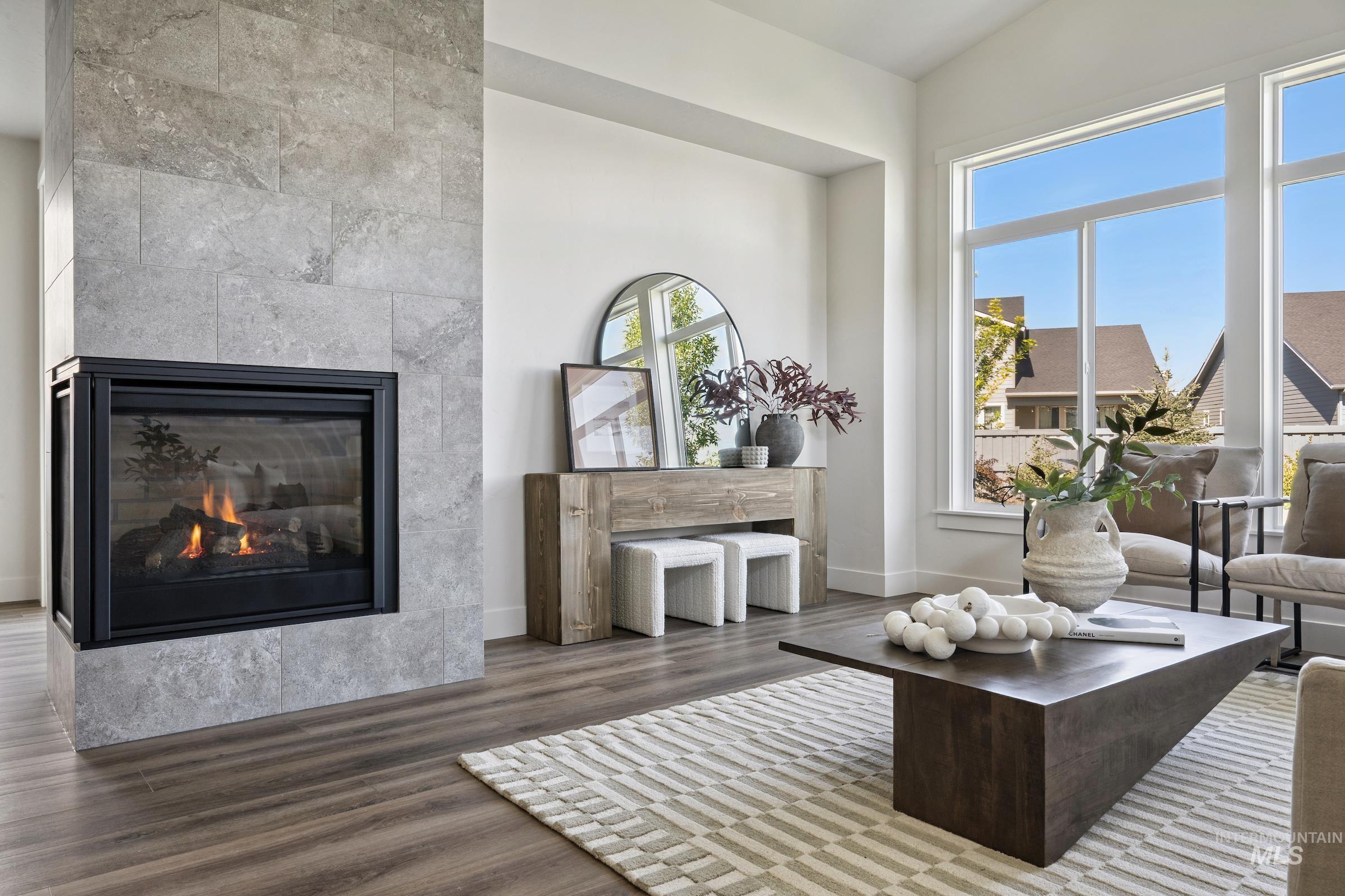 Living area with wood finished floors and a tile fireplace
