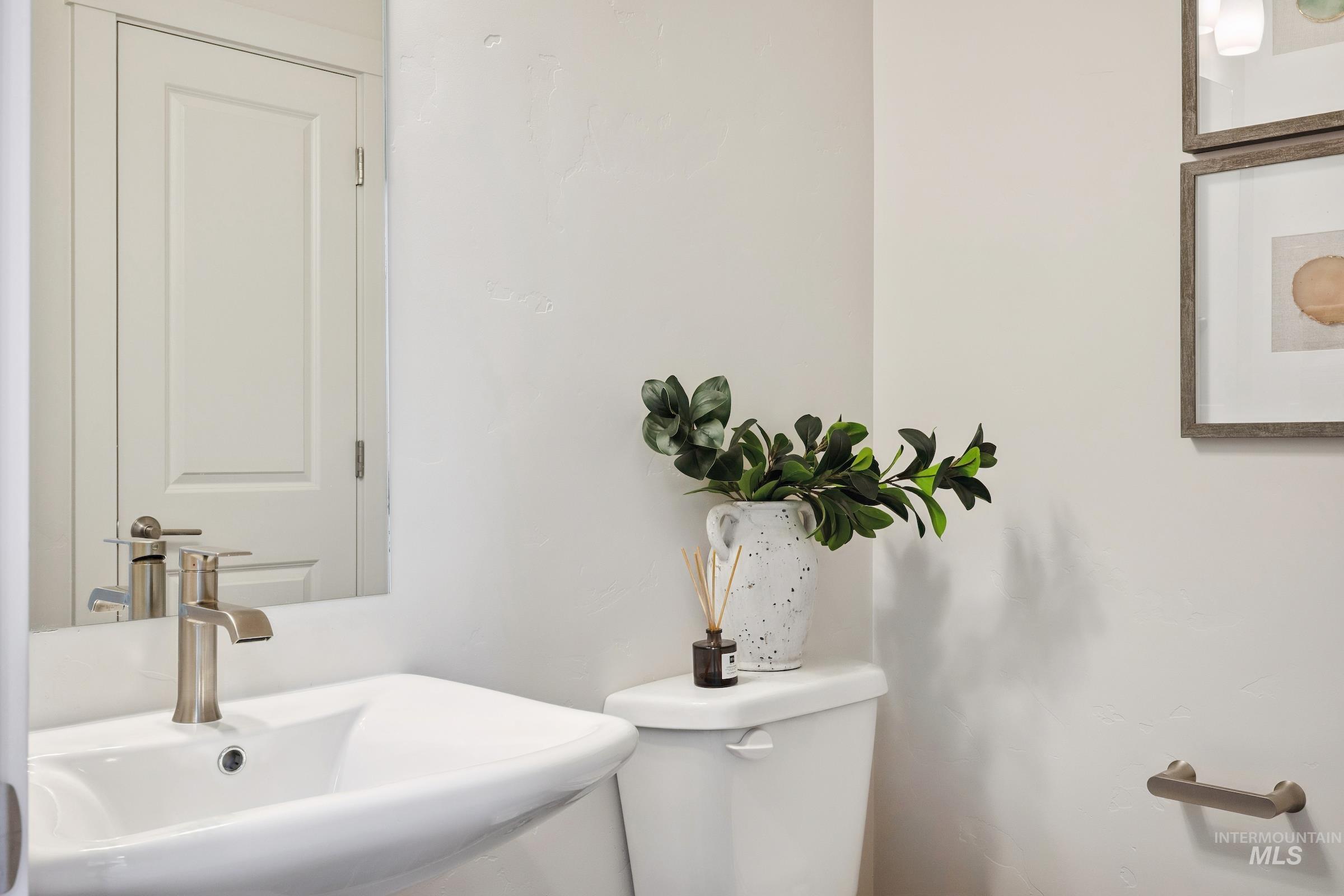 Half bathroom featuring a sink and toilet